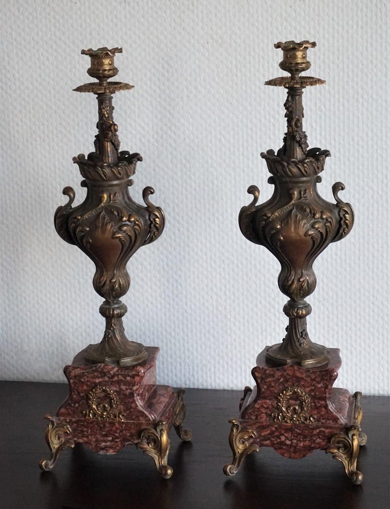 Pair of tall classical urn form candleholders of cast patinated and parcel gilded bronze richly ornate with foliage and floral motifs, on red griotte marble base with gilt bronze feet, circa 1880-1889.
Measures:
Height 20 in (51 cm)
Width 6.50 in