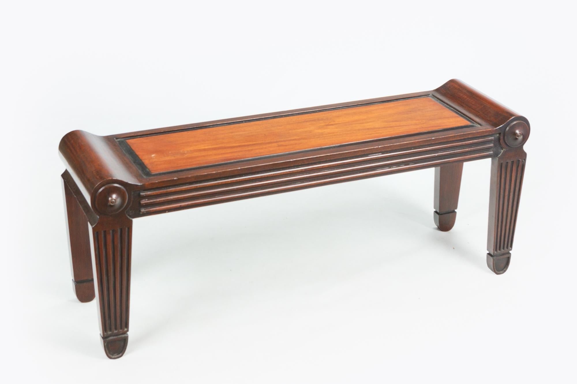 Inspired by a classical Roman marble seat, Charles Heathcote Tatham’s benches were distinguished by their fluted tapering legs, roundels, and paneled seats. This late 19th century pair of benches in the manner of Tatham adheres precisely to that