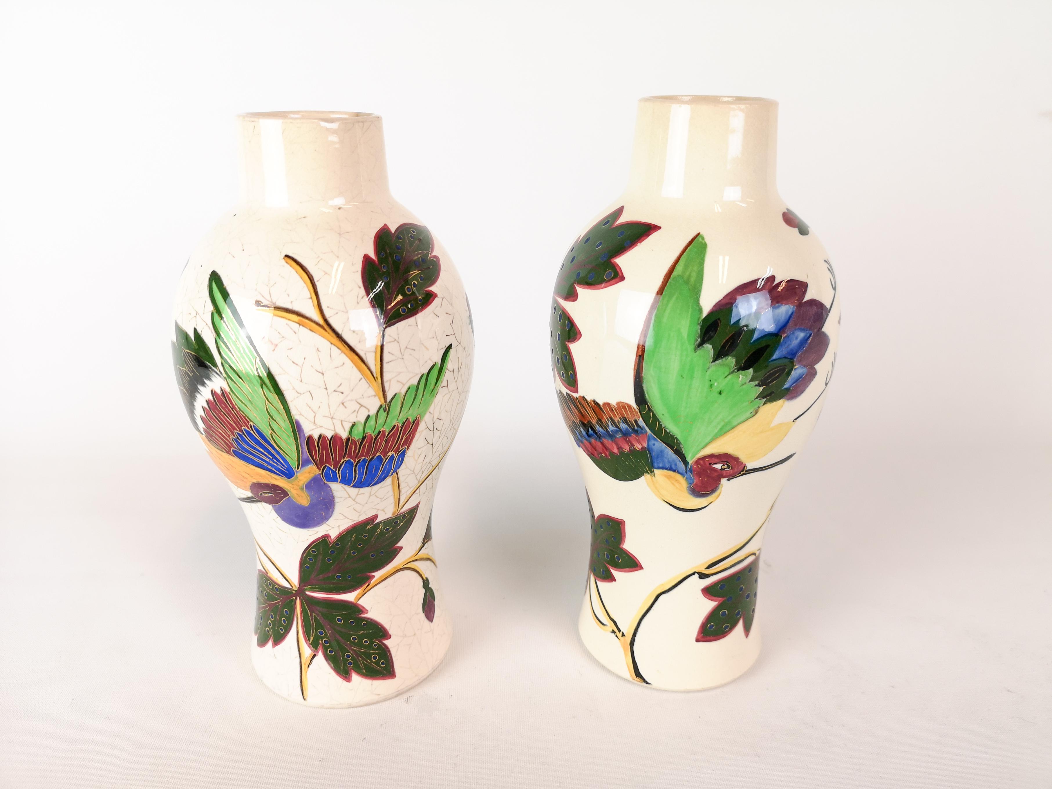 Wonderful pair of Art Nouveau vases. Manufactured at Gustavsberg Porcelain Factory in 1887 Sweden. 
The both shows signs of the typical Art Nouveau expressions in flowers and birds. 

They both have wear consistent with age and use. But in good