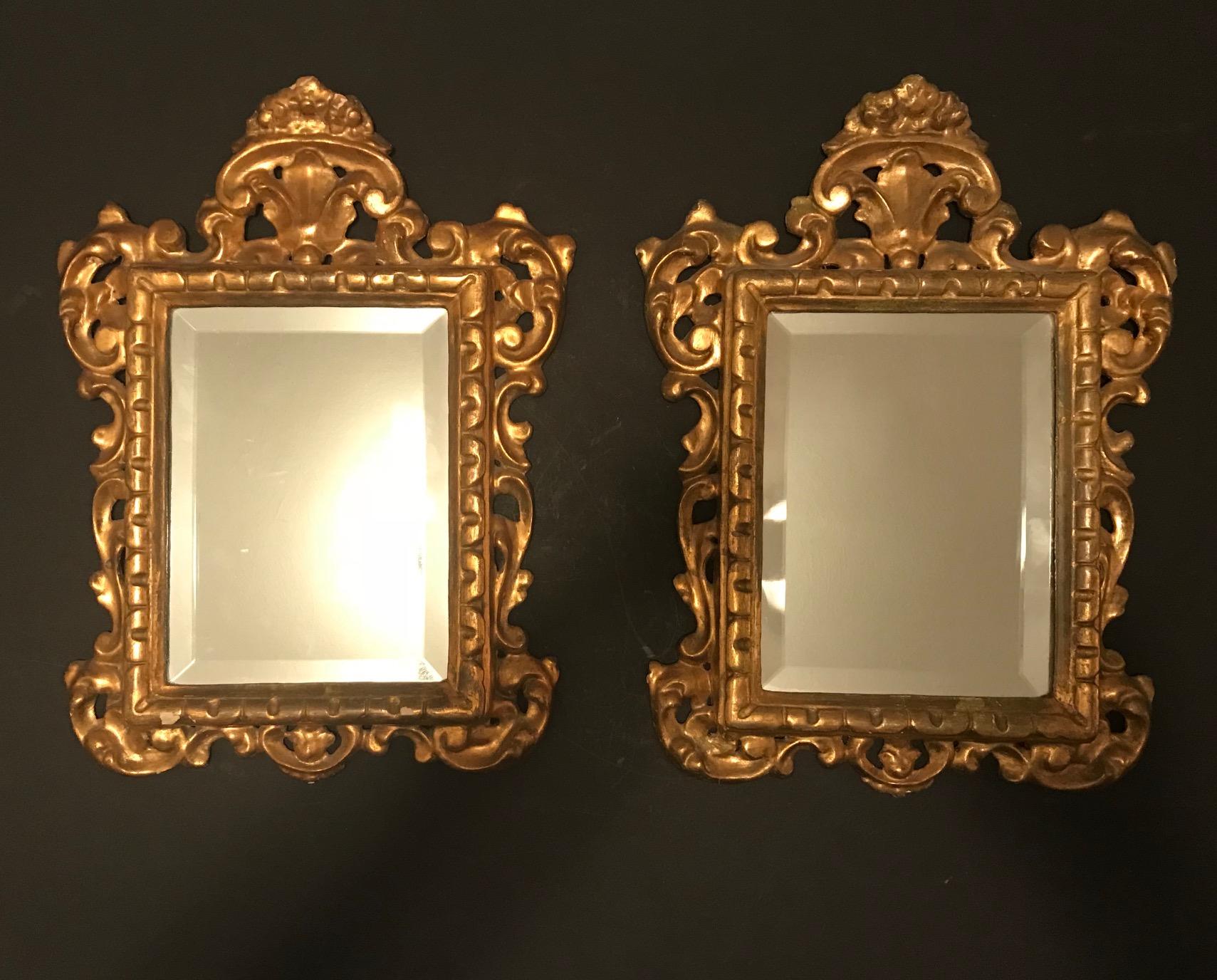 This is a pair of Venetian giltwood mirrors. The rectangular mirror plates are within a boldly carved scrolling acanthus frame with a carved leaf crown piece. The elaborately carved frame has the original water gilding.

Venetian style refers to