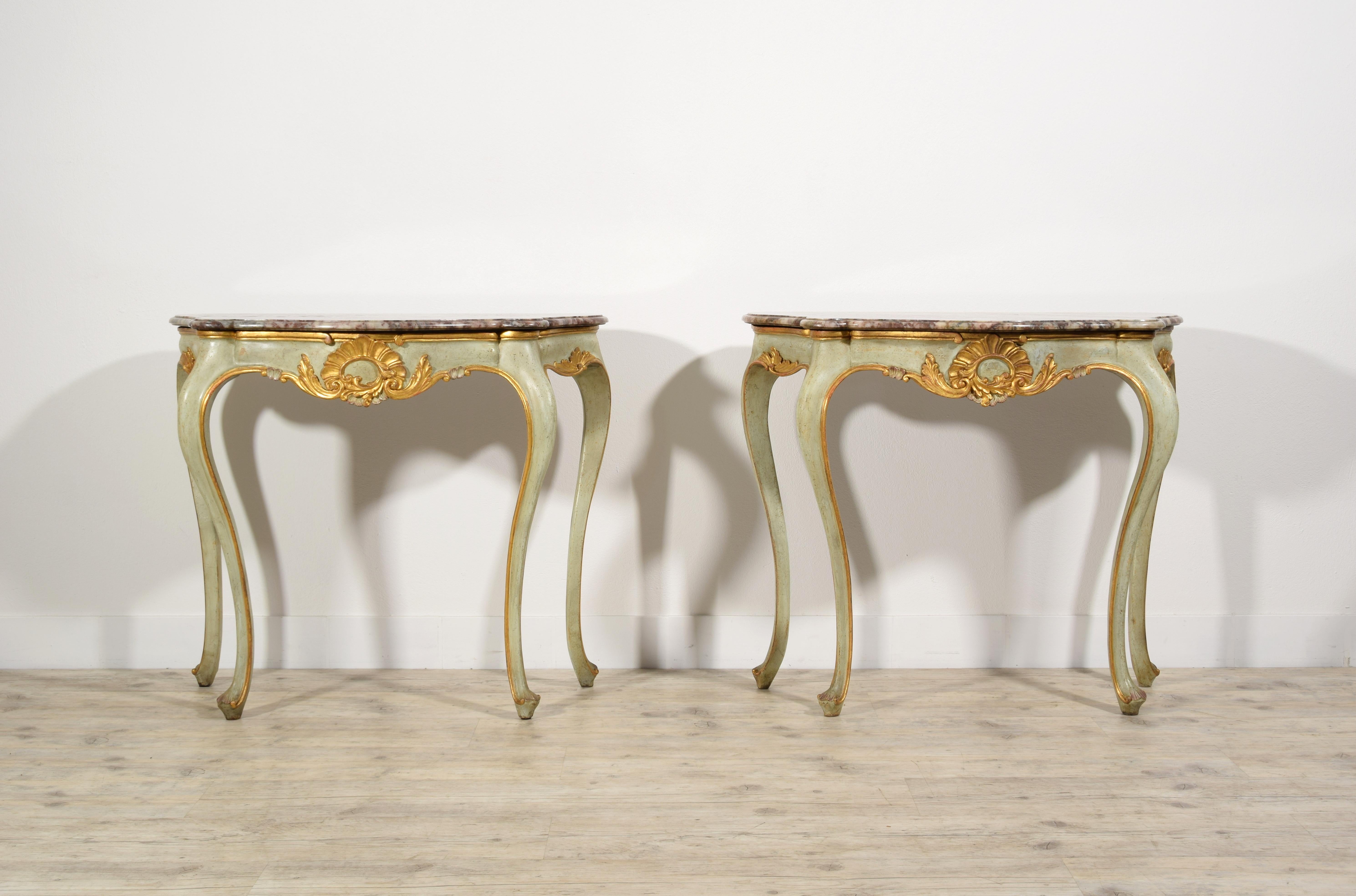 19th Century, Pair of Italian Louis XV style Lacquered Woos Consoles

This small pair of consoles was made in the early nineteenth century in Venice in carved, lacquered and gilded wood. The top, with a wavy and shaped profile, is in marble. The