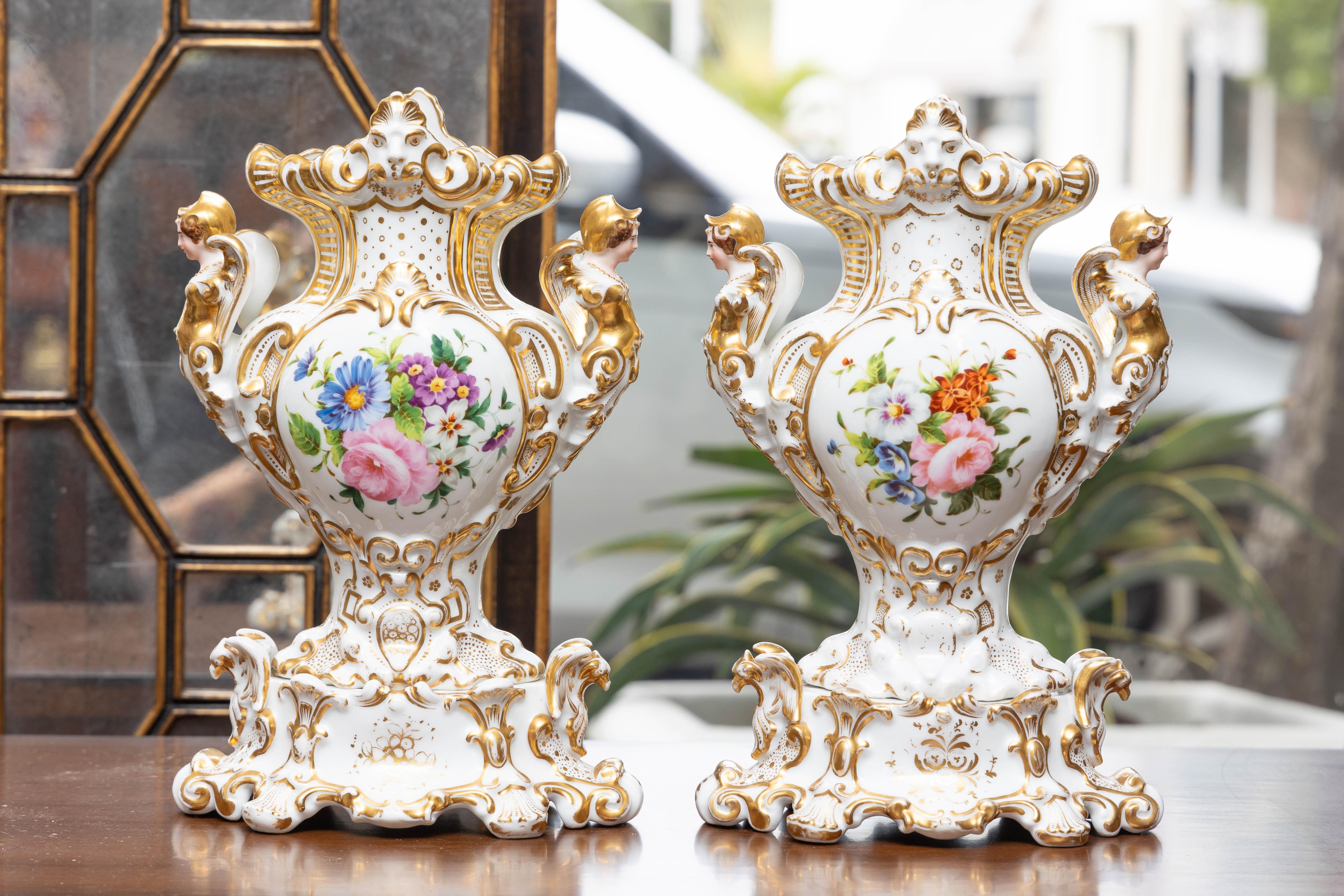 This is a lovely romantic pair of French Vieux Paris vases with a central medallion depicting a young man and young girl posed in a naturalistic rural setting.  The images are cast against a white porcelain and parcel gilt background, 19th century.