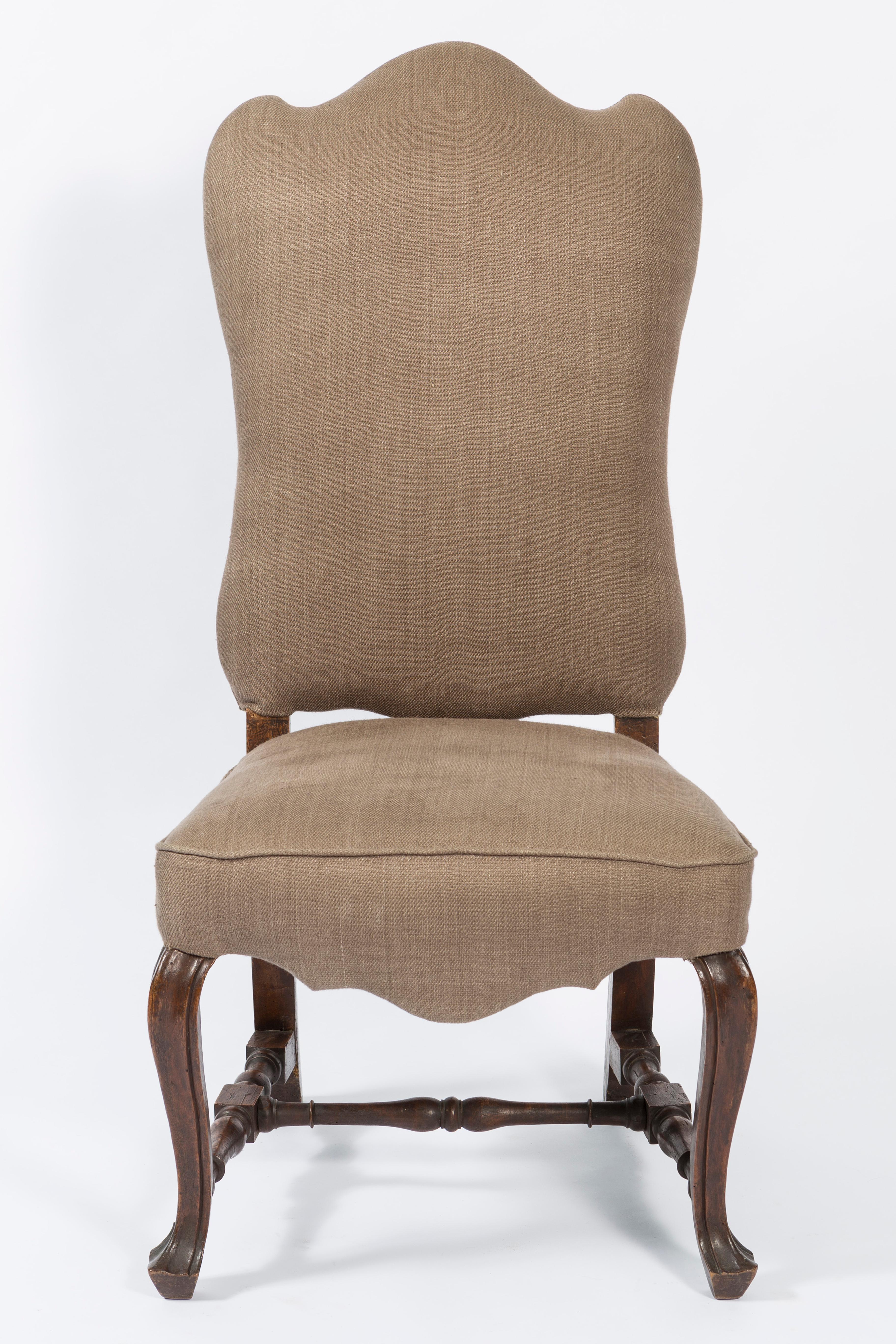 19th century pair of walnut Italian side chairs with shaped back. The legs are of a scroll design and the seat is shaped on the bottom on three sides. The pair of chairs is covered in a brown linen fabric. Please note the fabric in the pictures.  