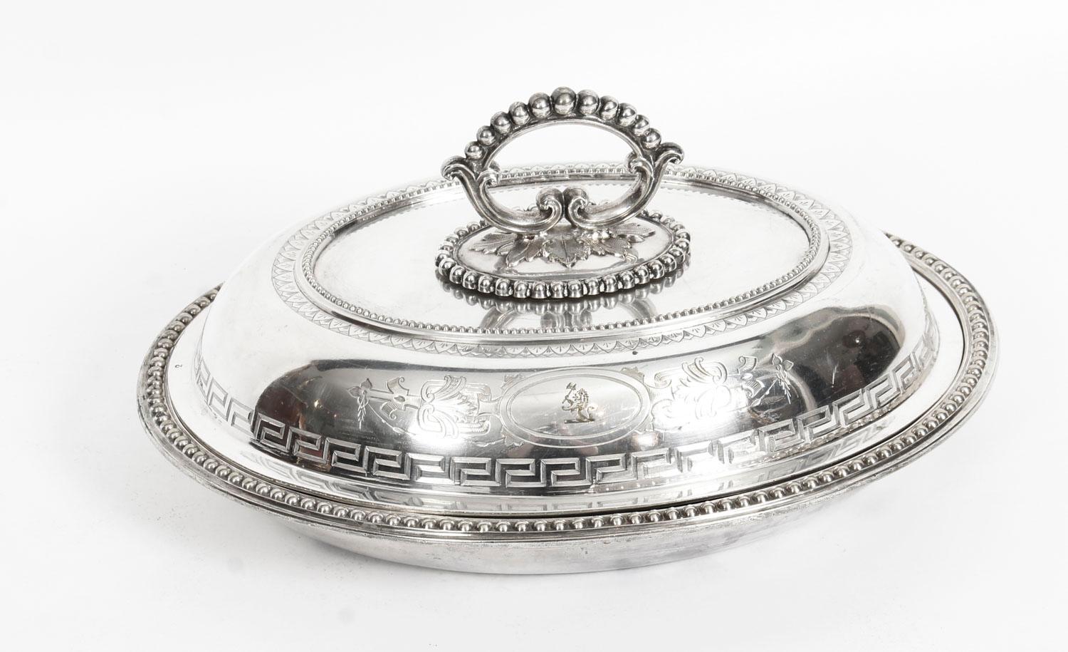 This is an a fine antique pair of English neoclassical silver plated entree dishes by the Goldsmiths Alliance Ltd Cornhill, London, circa 1860 in date.
 
The bright-cut engraving features leafy strapwork and bands of Greek key pattern. The