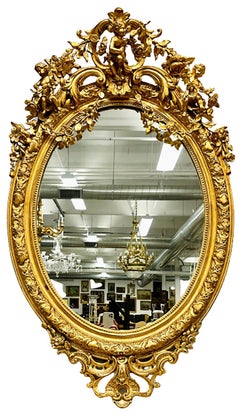 19th Century Palatial Giltwood Wall or Console Mirror Adorning Three Cherubs