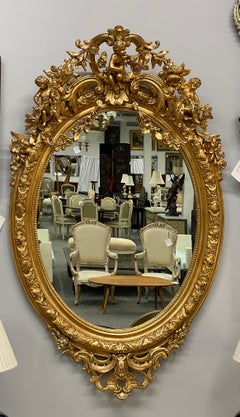 19th Century Palatial Giltwood Wall or Console Mirror Adorning Three Cherubs