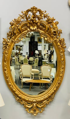 19th Century Palatial Giltwood Wall or Console Mirror Adorning Three Cherubs