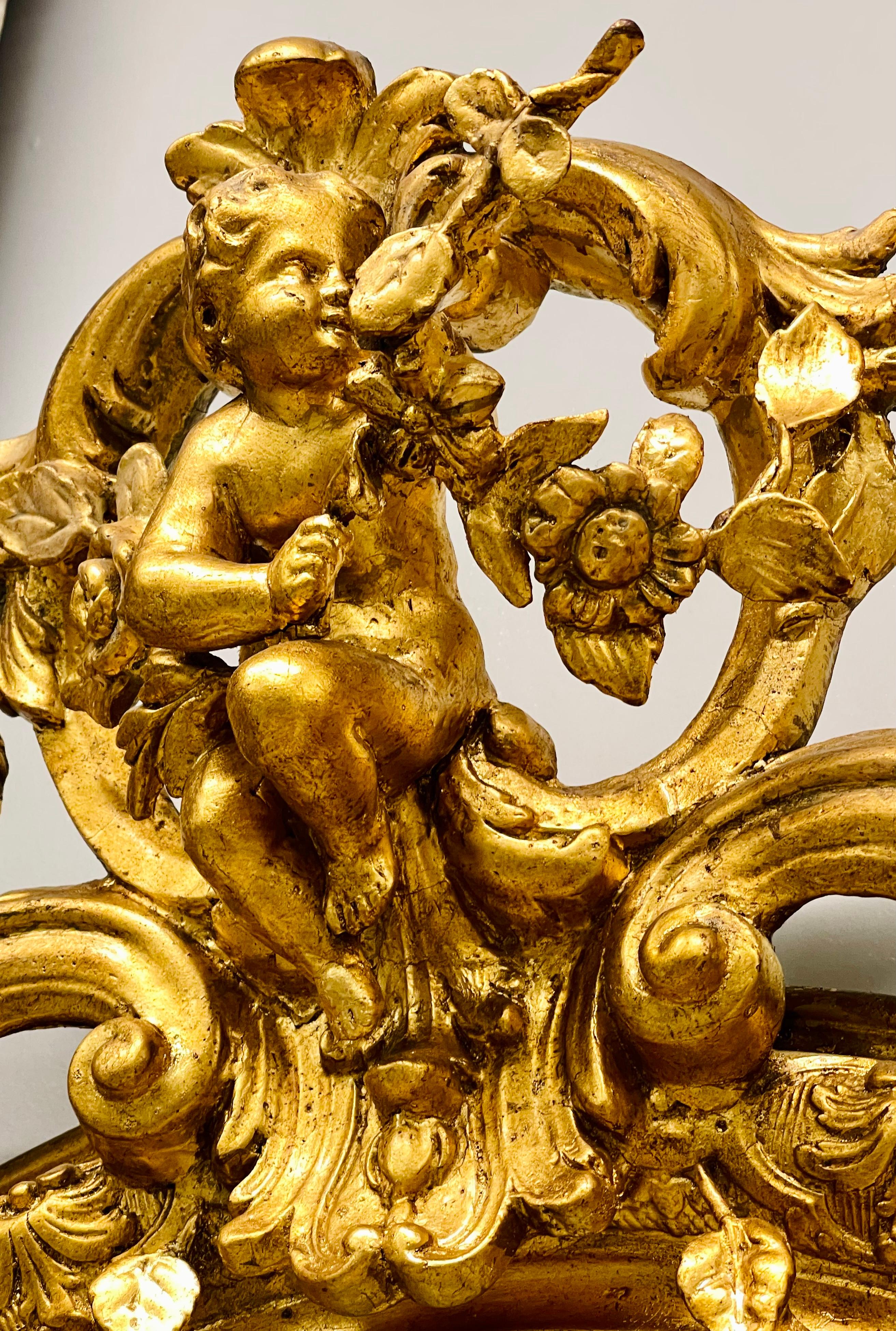 19th Century Palatial Giltwood Wall or Console Mirror Adorning Three Cherubs In Good Condition In Stamford, CT