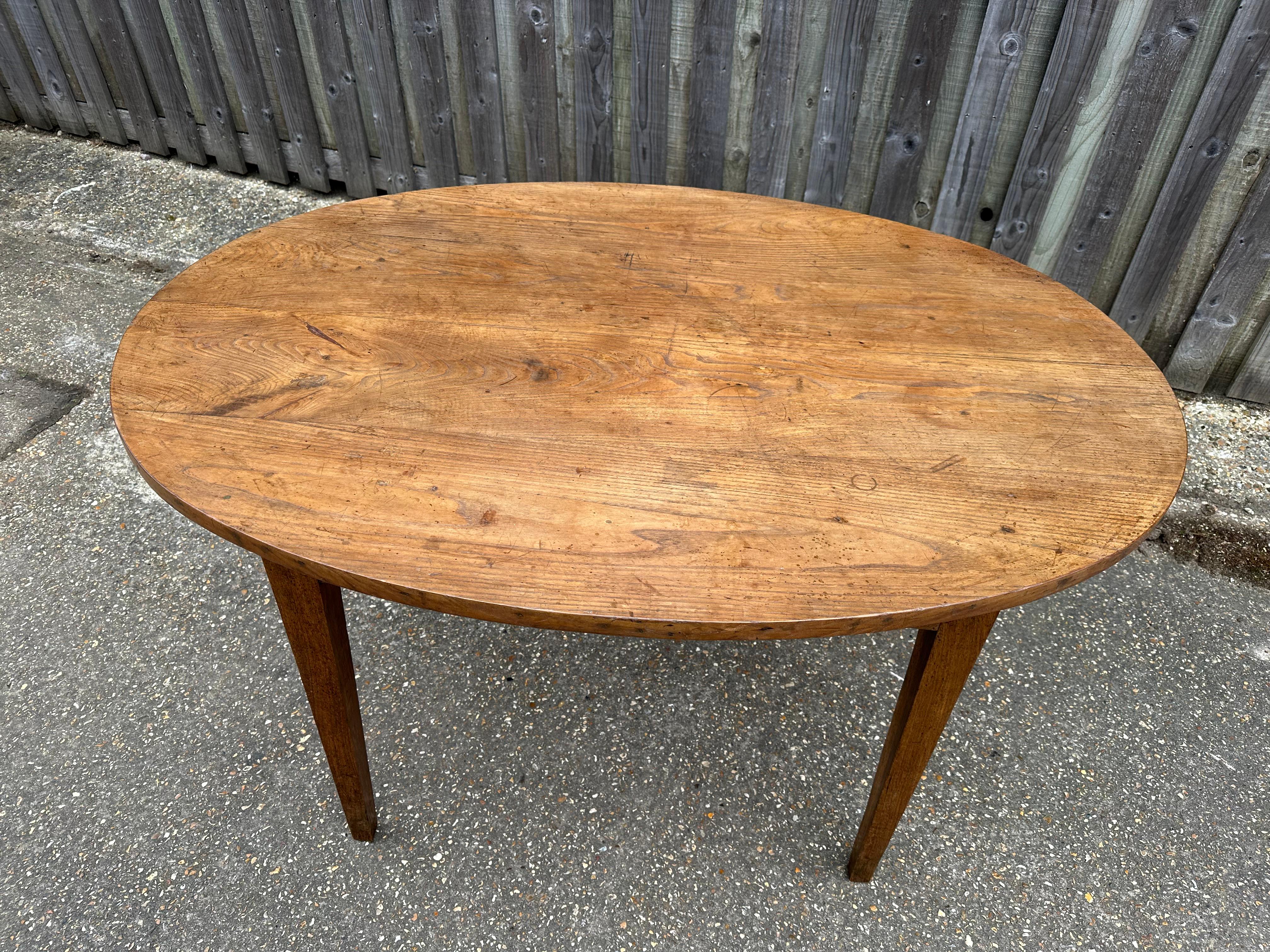 19th Century Pale Oak Oval Dining Table with side drawer and tapered legs. Plenty of leg room and good patination. Apron height 24.5
