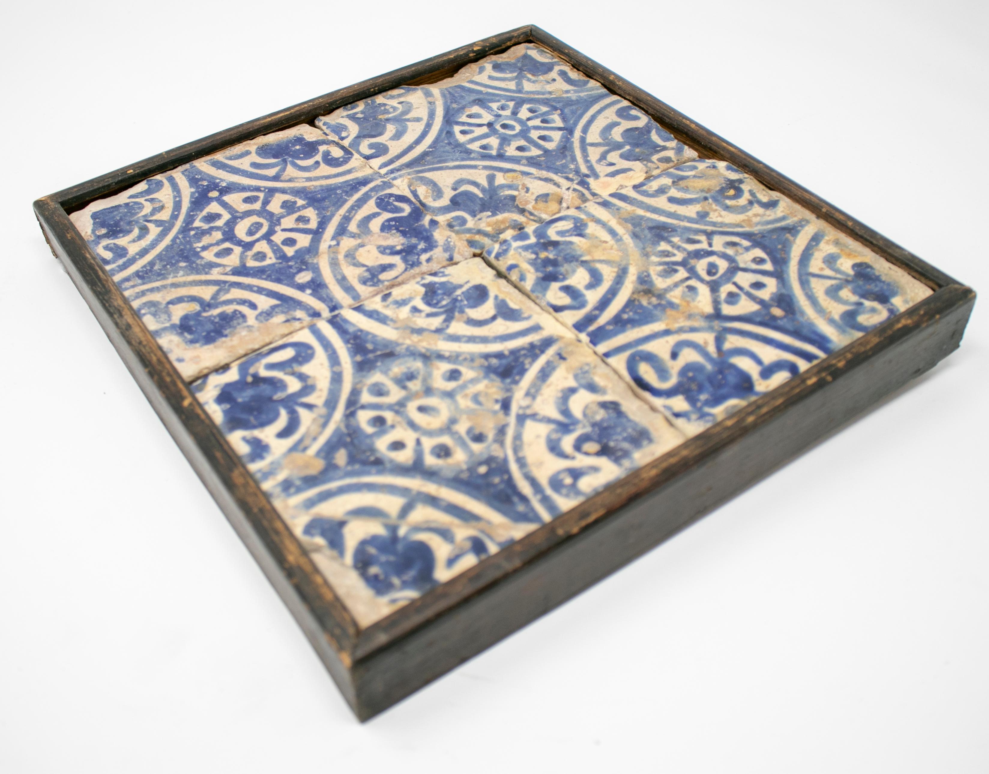 19th century framed panel with four Spanish glazed Manises blue cobalt painted tiles.