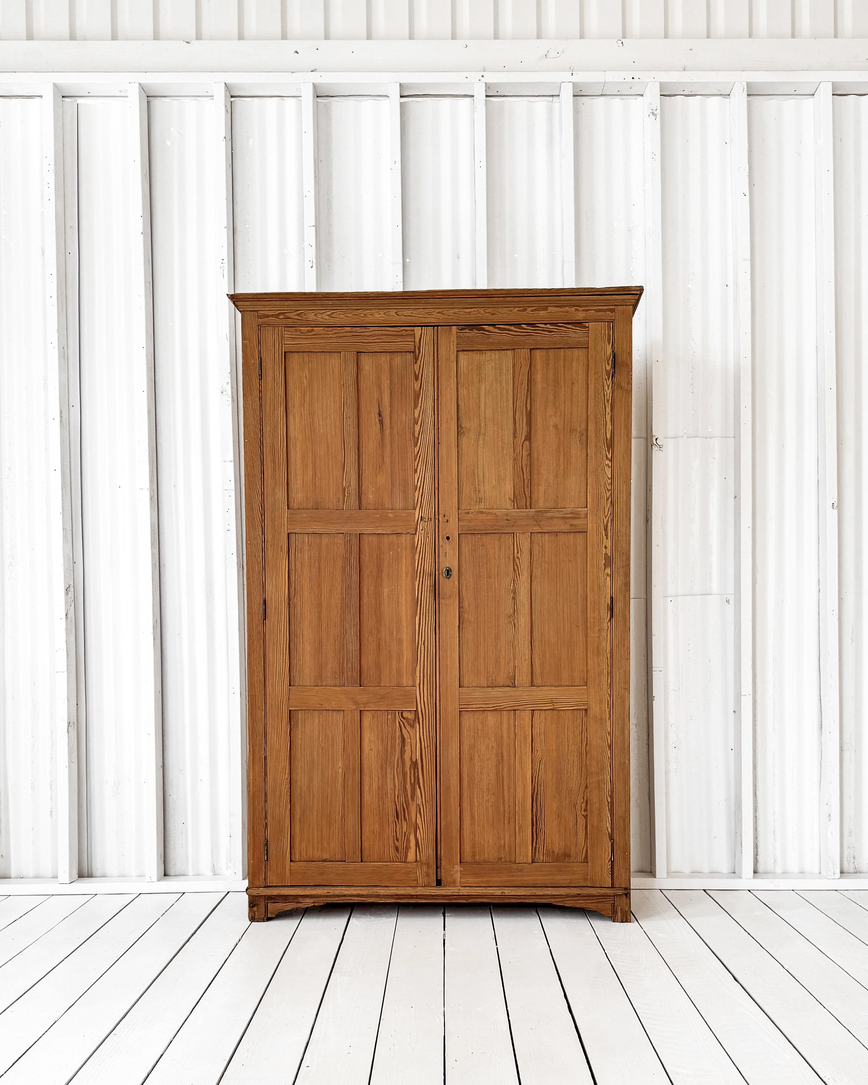 Once built into an English scullery for extra storage, this handsome cupboard is now a standalone piece guaranteed to keep your home clutter-free. Having an overall straightforward design, the cupboard is dressed up with crown molding and bracket