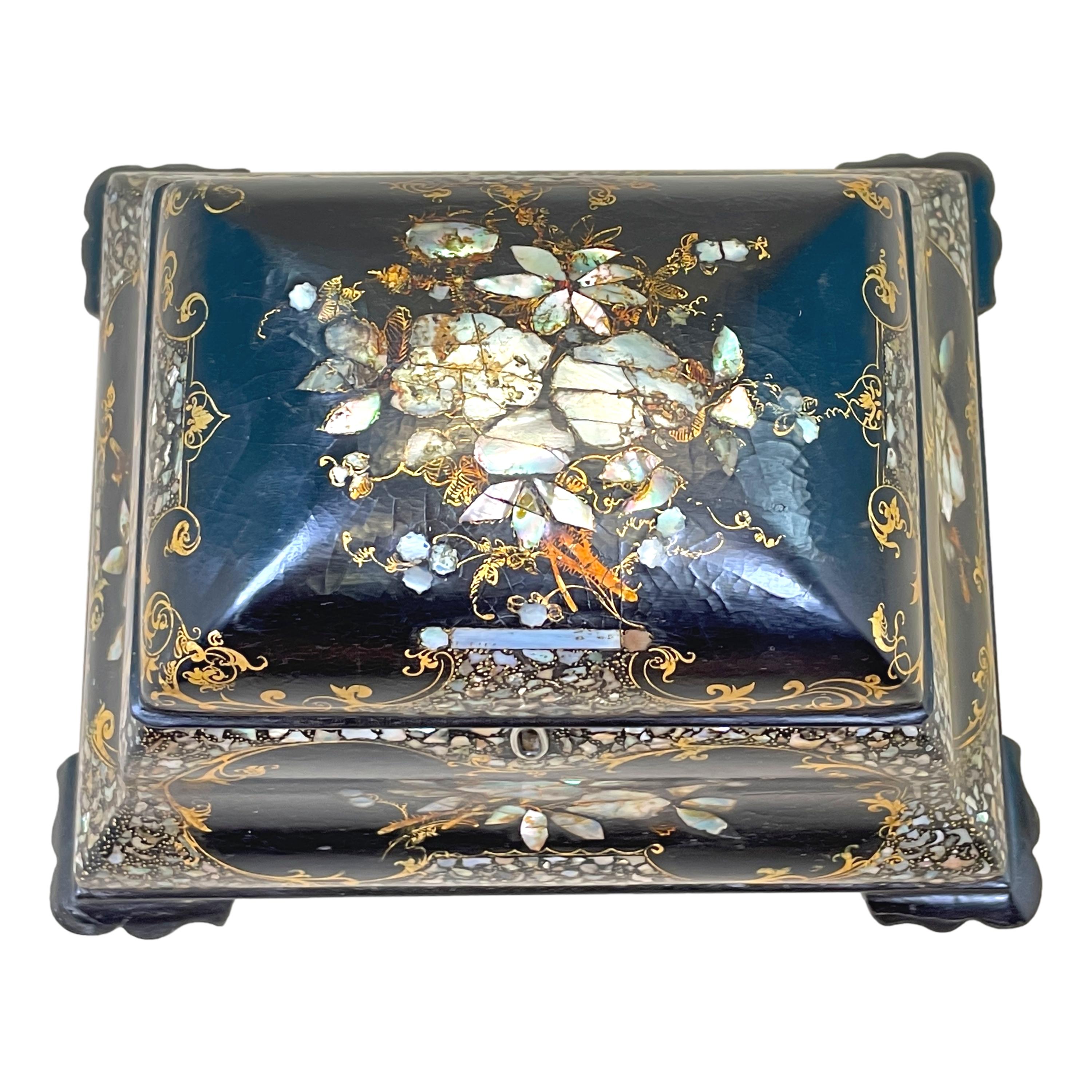 A very elegant mid-19th century papier mache tea caddy, of bombe type form, having exceptional hand painted and inlaid decoration, the hinged top enclosing lidded compartments raised on original shaped feet.

This charming little 19th century tea