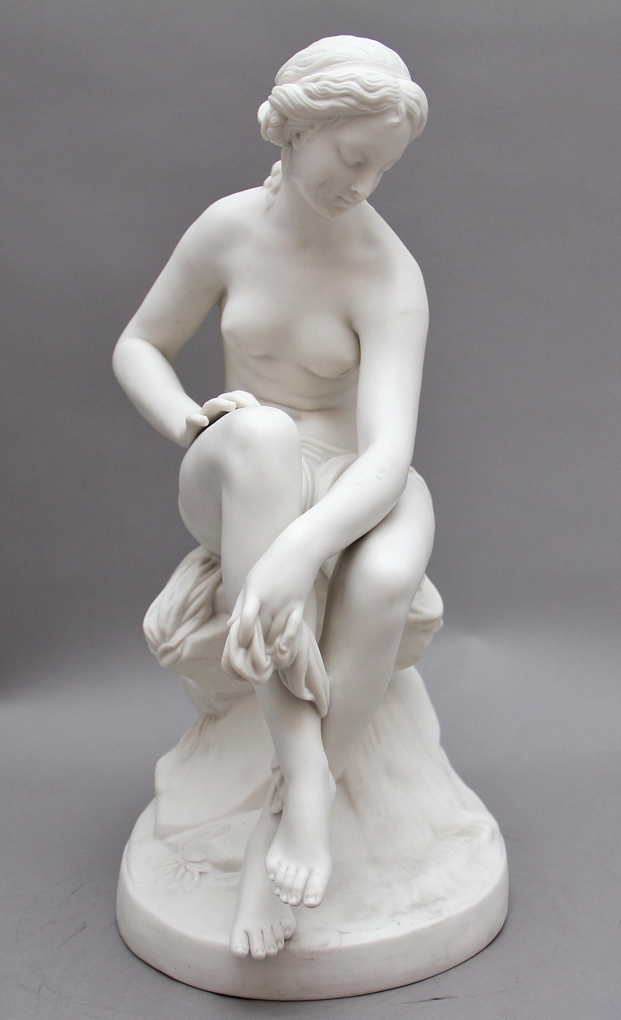 19th century parian figure of a female nude sitting on a blanket on a rock formation. Circa 1850.

 