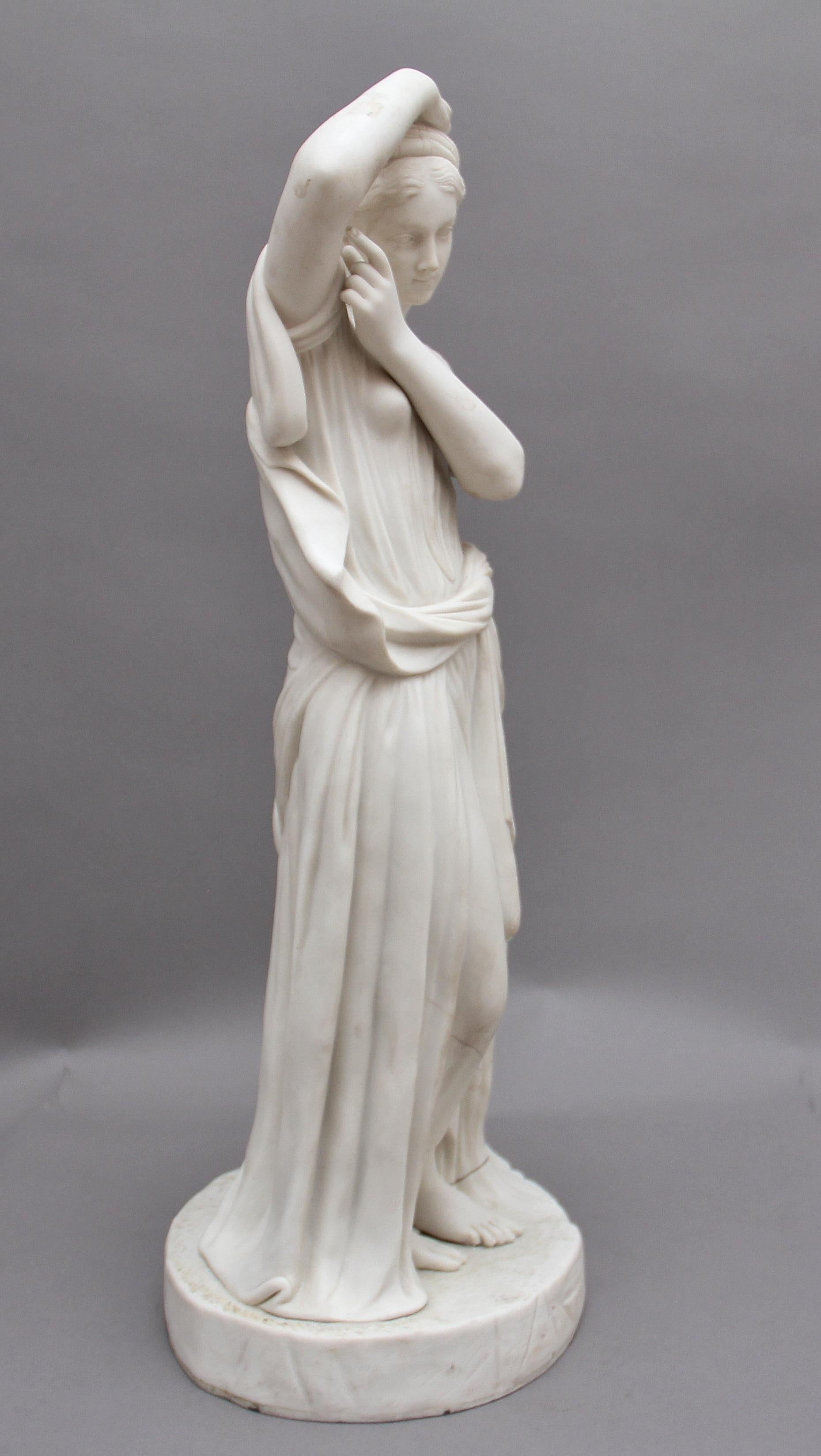 A superb quality 19th century parian figure of a Greek lady, the figure shows the lady dressed in a typical Greek dress standing next to a boulder with a water jug on top. There are some cracks on the base but all in all in great condition. Circa