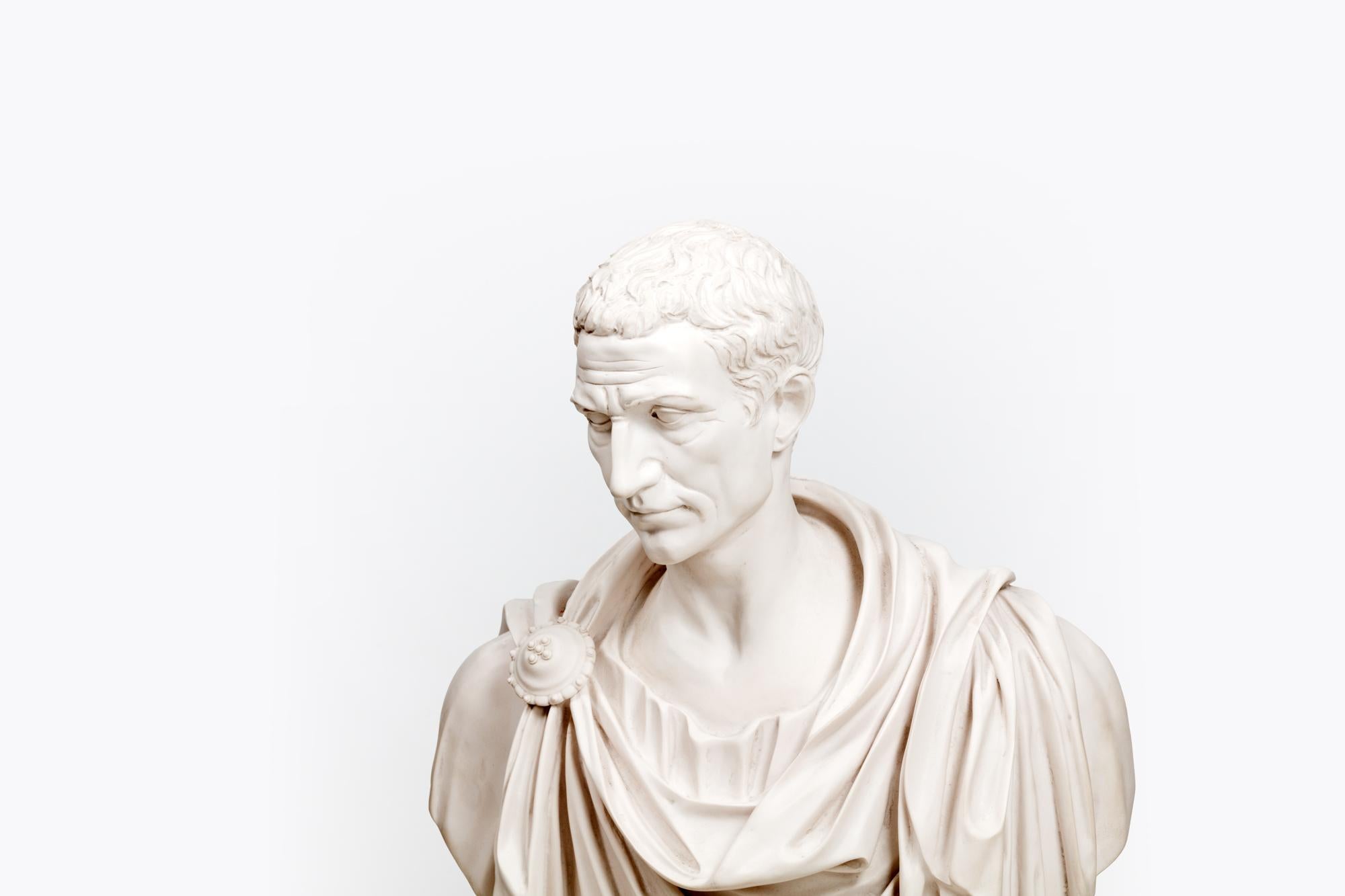 19th Century Parian ware portrait bust of Roman Emperor Julius Caesar in draped toga.

Parian ware is a type of biscuit porcelain which imitates the style of carved marble.

Gaius Julius Caesar was a Roman general and statesman and a distinguished