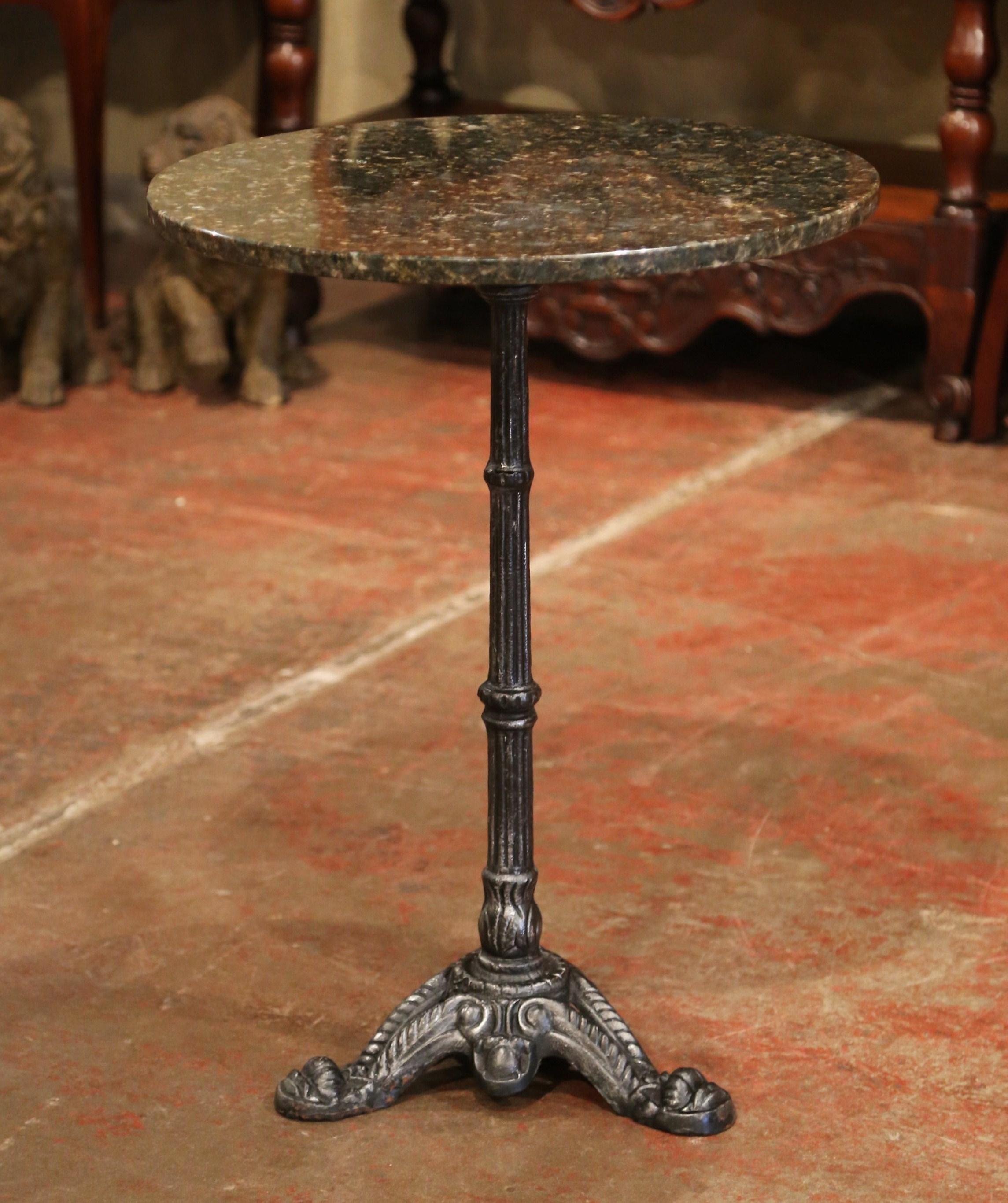 This exquisite, antique Napoleon III gueridon was crafted in Paris, France, circa 1870. The classic bistrot table features a round grey black marble top with grey veins and a long, thin iron stem finished with three paw feet at the base. The French