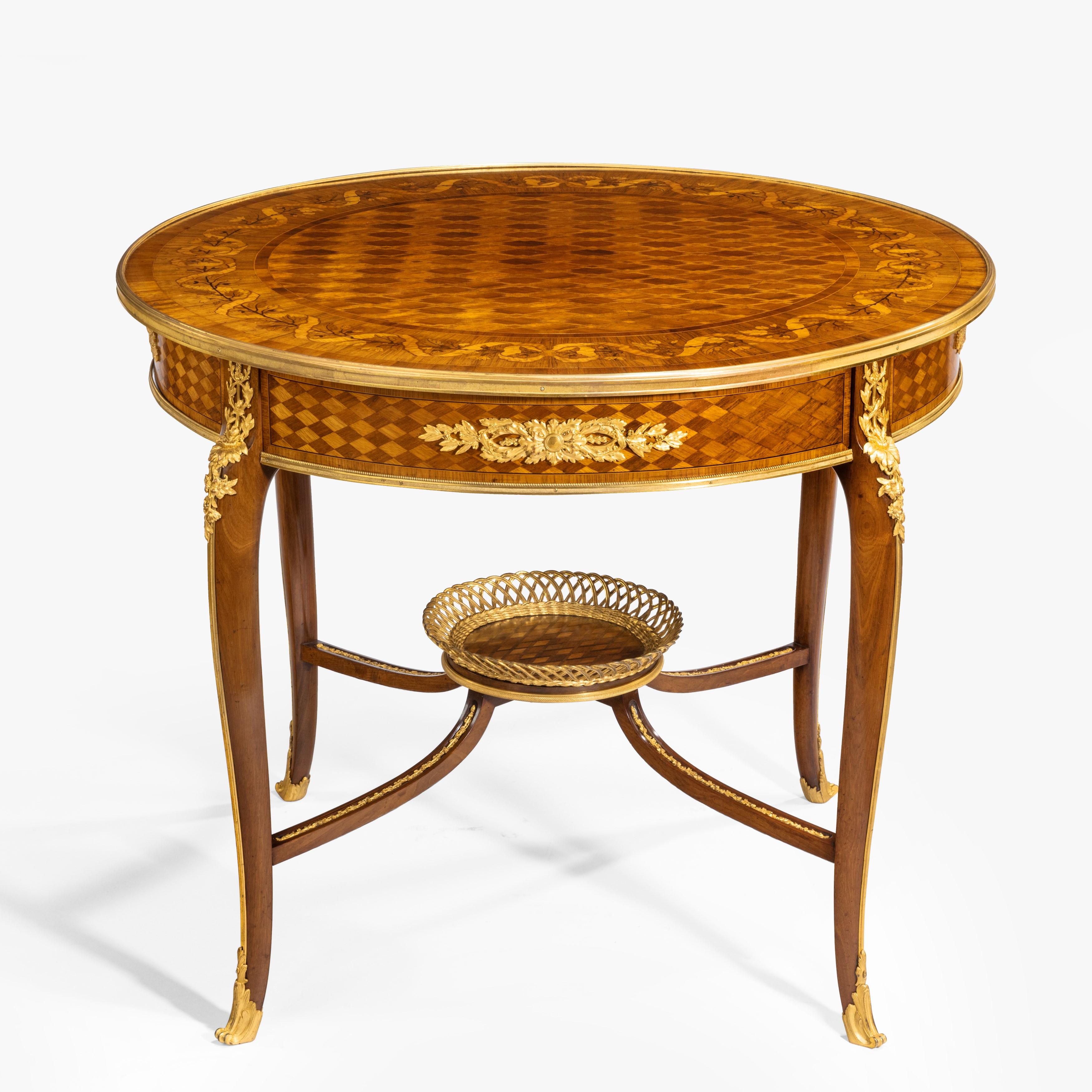 A Louis XVI style parquetry centre table
firmly attributed to François Linke

Constructed in Kingwood, Tulipwood and Mahogany, with foliate inlay work, parquetry and Fine ormolu bronze mounts; of free-standing circular form, the ormolu sabot