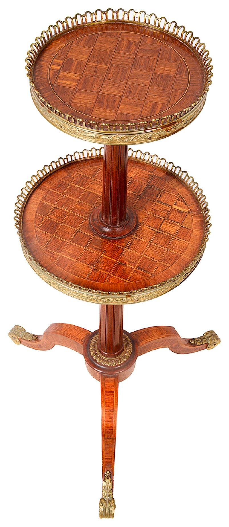 A good quality late 19th Century French Louis XVI style parquetry inlaid two tier etagere, with gilded ormolu gallery, raised on an out swept tripod base.