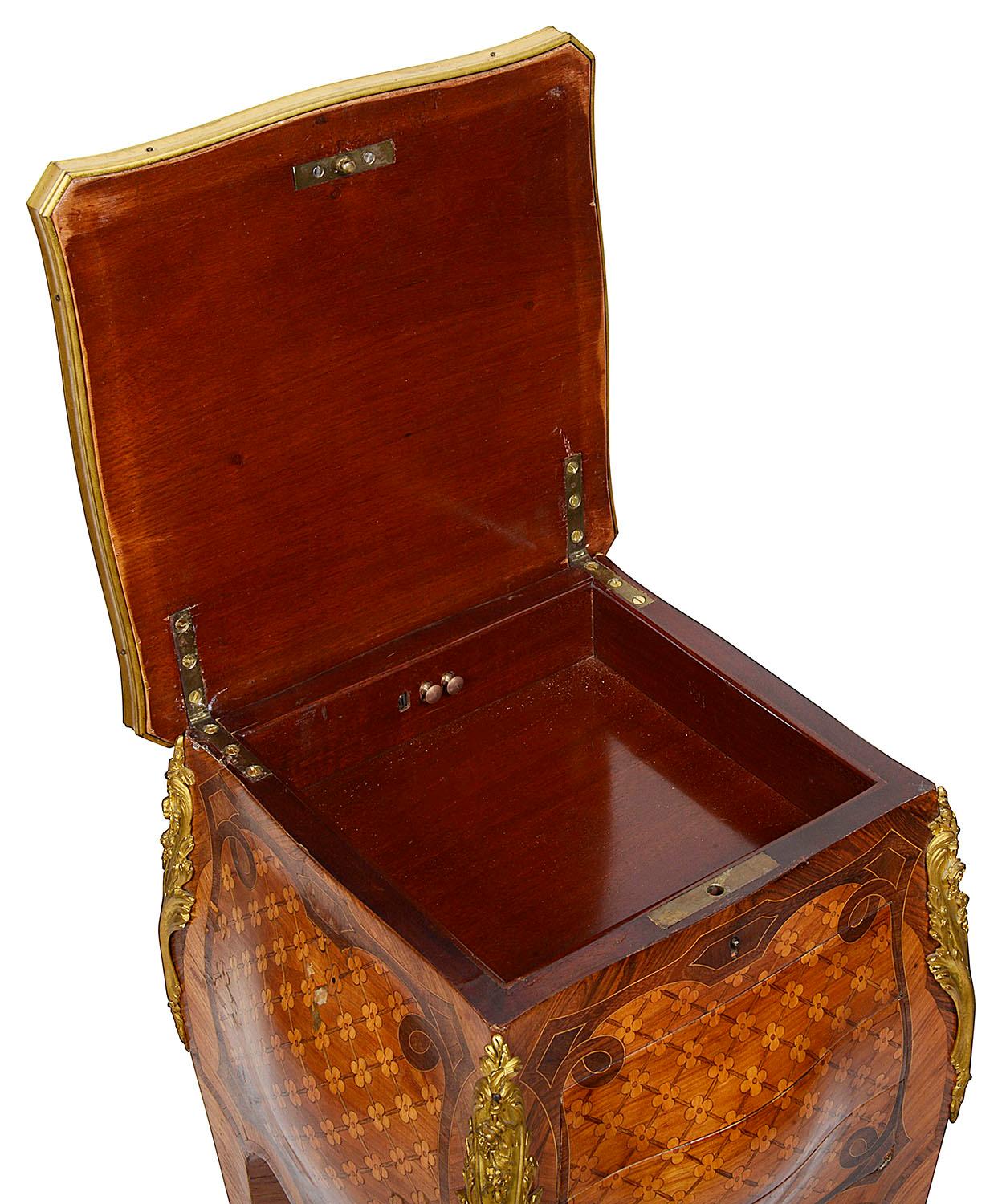 A very good quality late 19th century French Louis XVI style parquetry inlaid side table, having a hinged top, opening to reveal a compartment within. Three drawers beneath, raised on elegant cabriole legs, wonderfully fine quality gilded ormolu