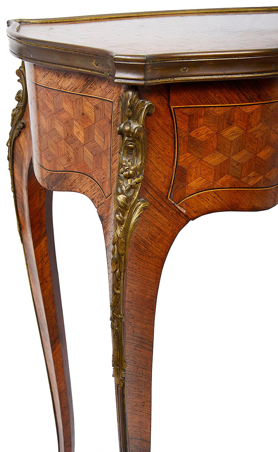 A fine quality late 19th century French freestanding Parquetry inlaid side table, having serpentine shaping to all sides, with a single oak lined frieze drawer, a gilded ormolu shell like escutcheon and matching mount to the reverse, raised on
