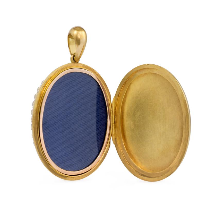 An antique gold and pearl locket, the front set with pavé pearls, in 18k.  (Single photo compartment.)  Approximately 2 3/4