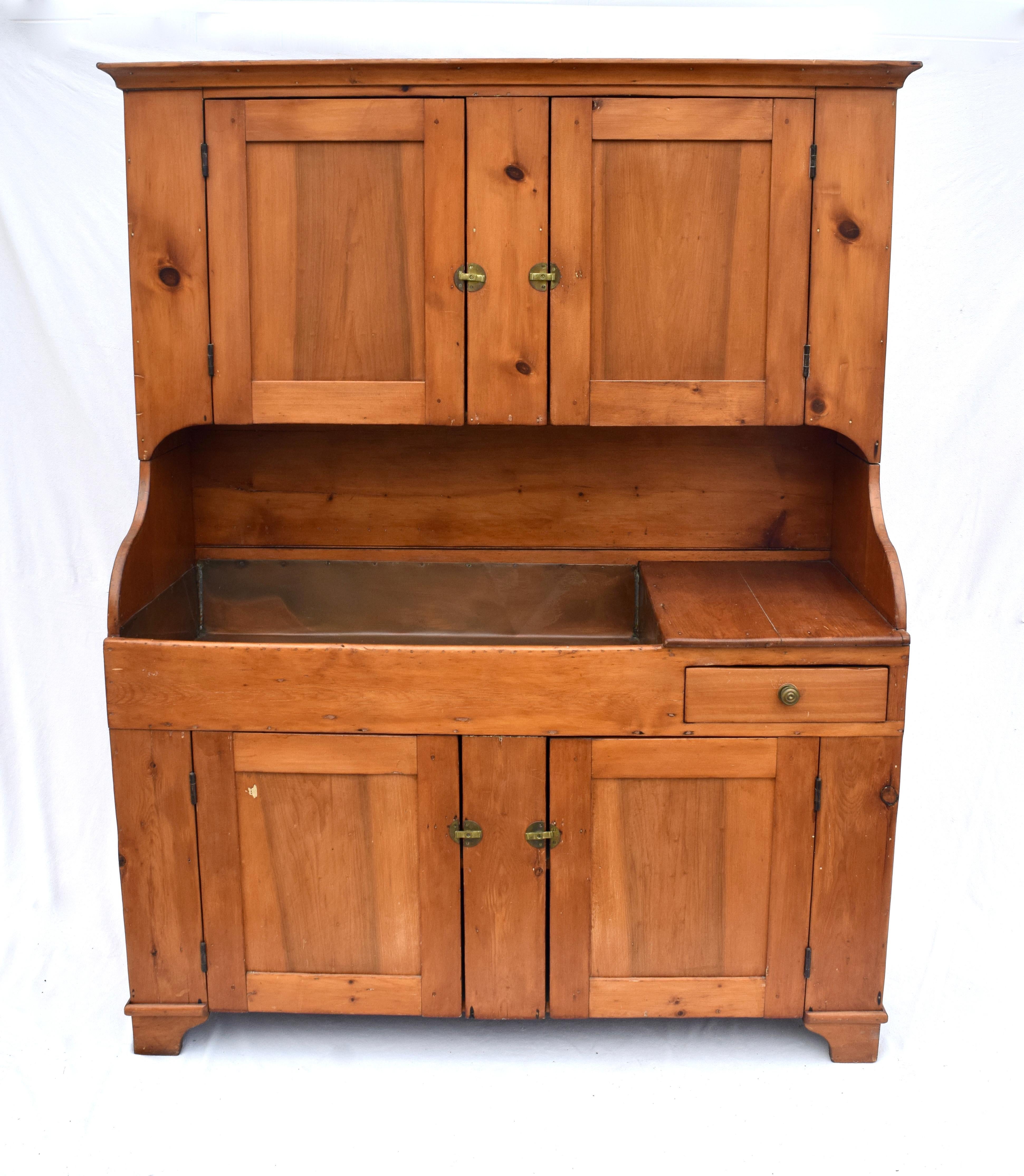 Antique American Pennsylvania step back cupboard with copper lined dry sink, green paint interior, dovetail top section & single dovetailed hand planed drawer. There are two sections each having one single stationary shelf. Unusually generous in