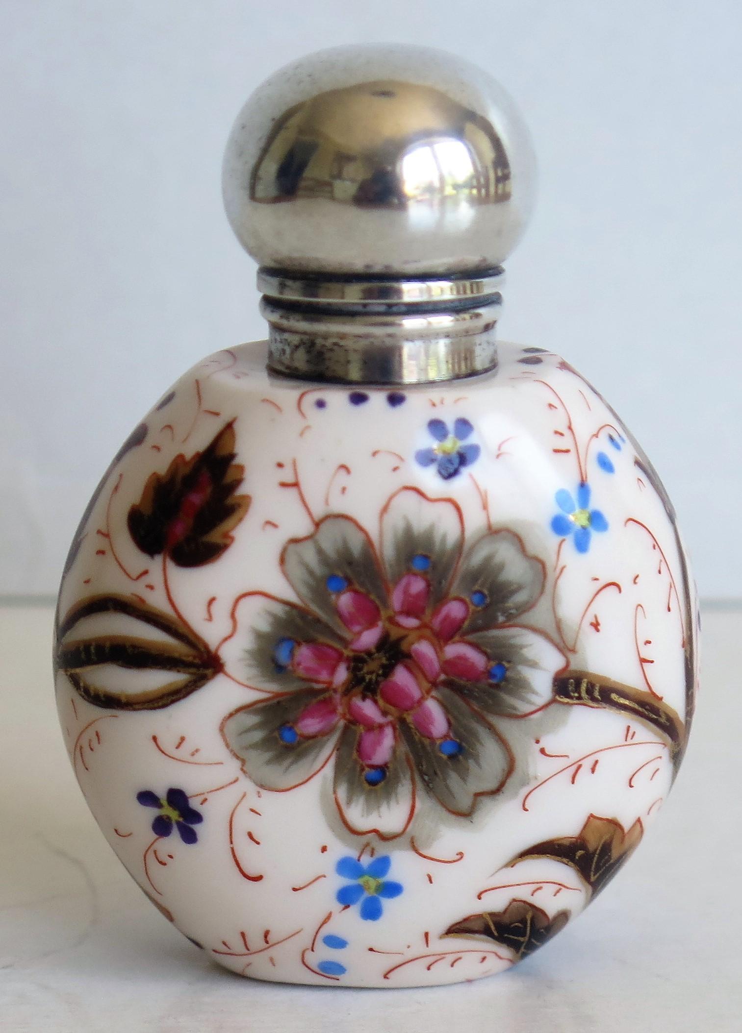 This is a very attractive hand-painted porcelain perfume or scent bottle. We think the bottle is English and we date it to the Victorian period of the 19th century, circa 1870. 

The bottle has a very tactile rounded shape and is made of