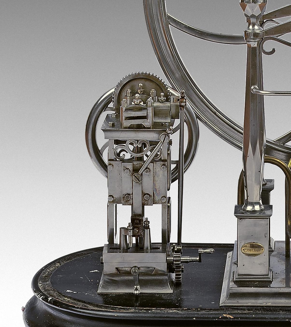 Steel scientific perpetual motion machine of an exceptional quality and in working order. Complex mechanism aiming at giving a wheel its full autonomy, remarkable steel work, assemblage and finishing. Mechanism signed T.Touchard. Museum quality