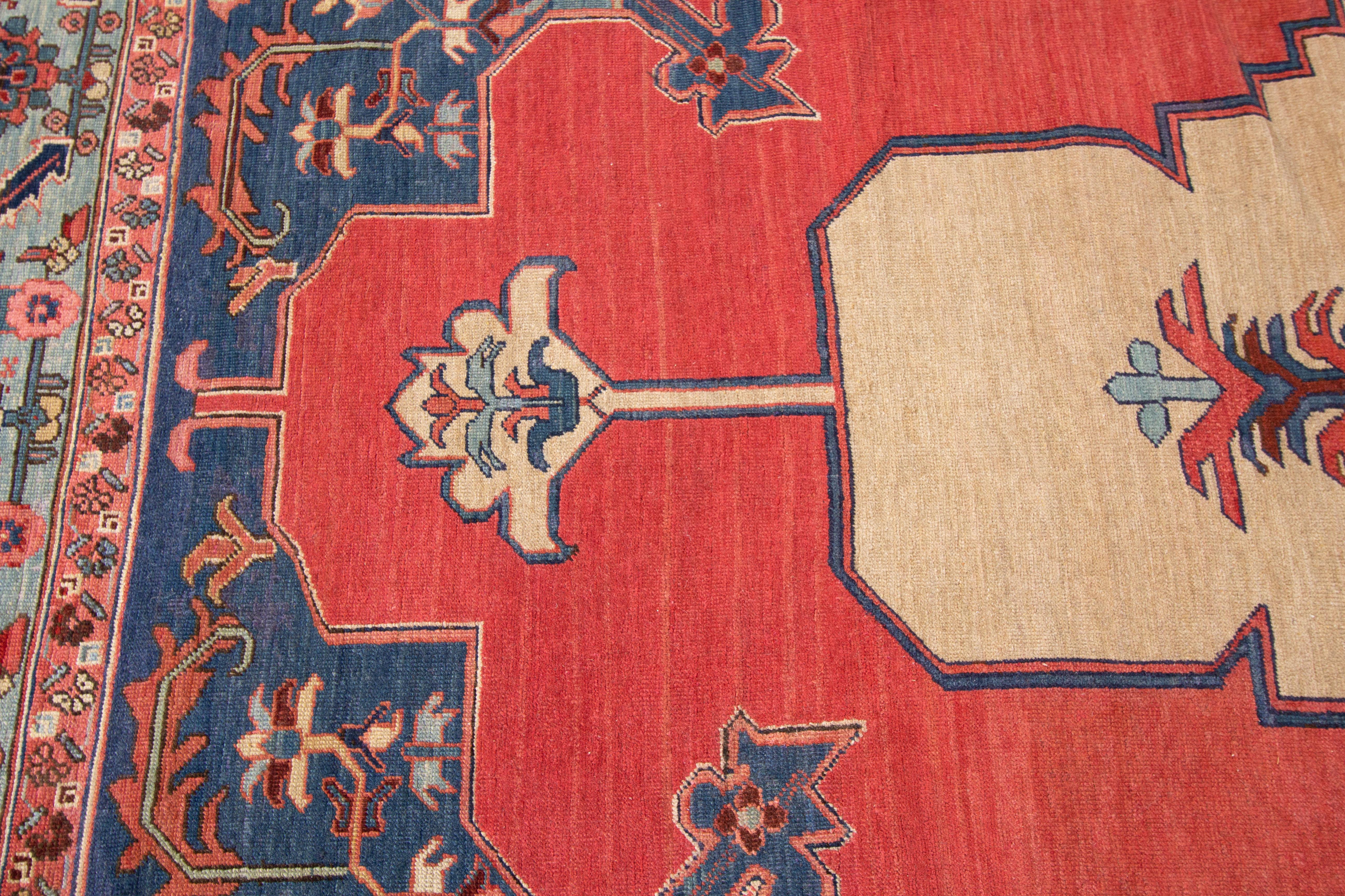 Antique Persian Bahshaeish rug (1890's) with a traditional medallion design in blue and cream on a red field. Measures approximately 11 feet 4 inches by 18 feet 5 inches.

Rug #10212224