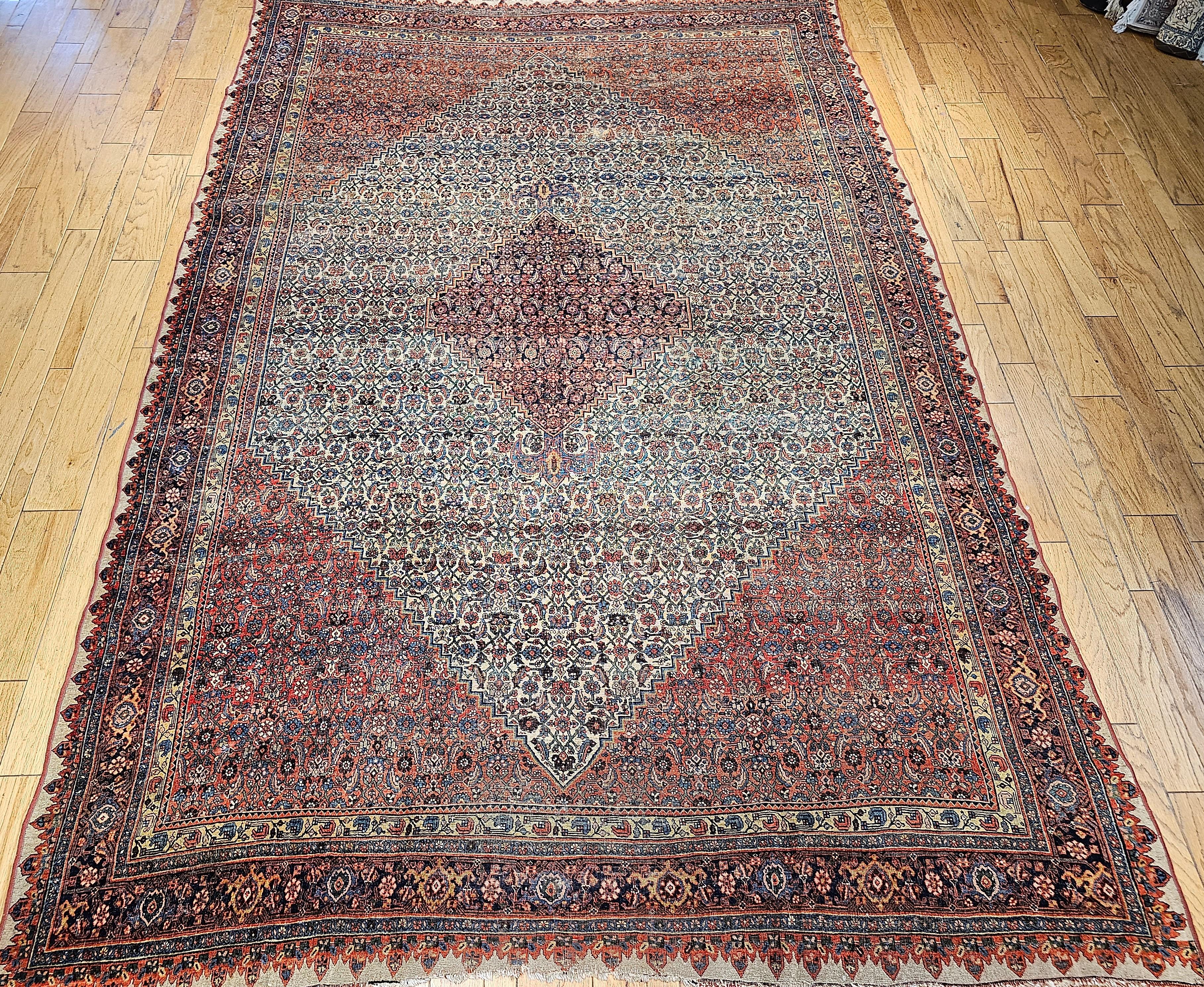 A beautiful Bidjar(Bijar) Halavi rug from the late 1800s.  The Bidjar has an Ivory field with a navy blue diamond-shaped medallion with light blue anchor pendants. It has a red subfield. The design is an uninterrupted Herati pattern in green, tan,
