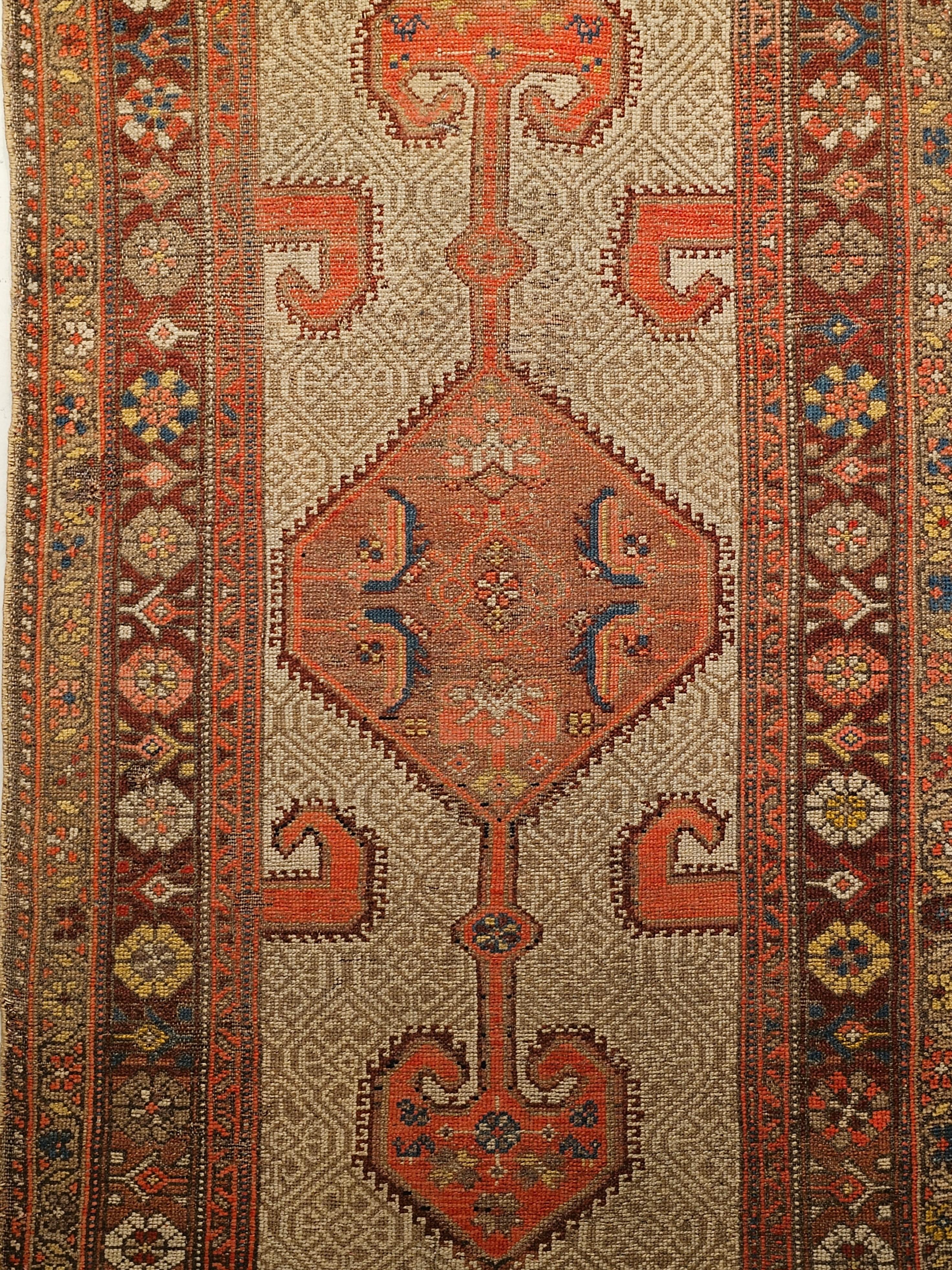 A vintage Persian Malayer runner in geometric pattern in camelhair, burgundy, rust red, and ivory colors.  This Persian Camelhair Malayer hand knotted rug is truly a masterpiece of village weaving from the late 1800s.   A large elongated hexagonal