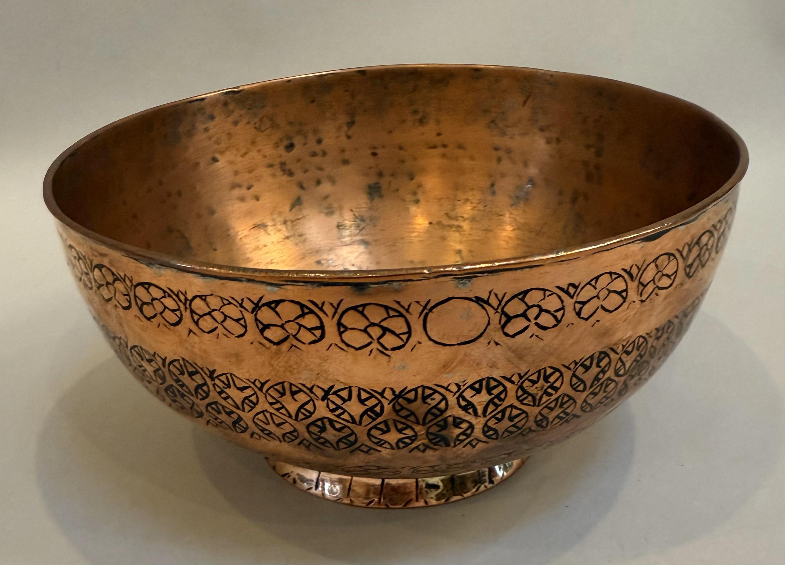 19th Century Persian Copper Bowl. Intricate hand-hammered geometric decoration with a splayed foot and wonderful patination.

An elegant 19th-century Persian copper bowl, made circa 1850, featuring intricate hand-engraved motifs encircling its