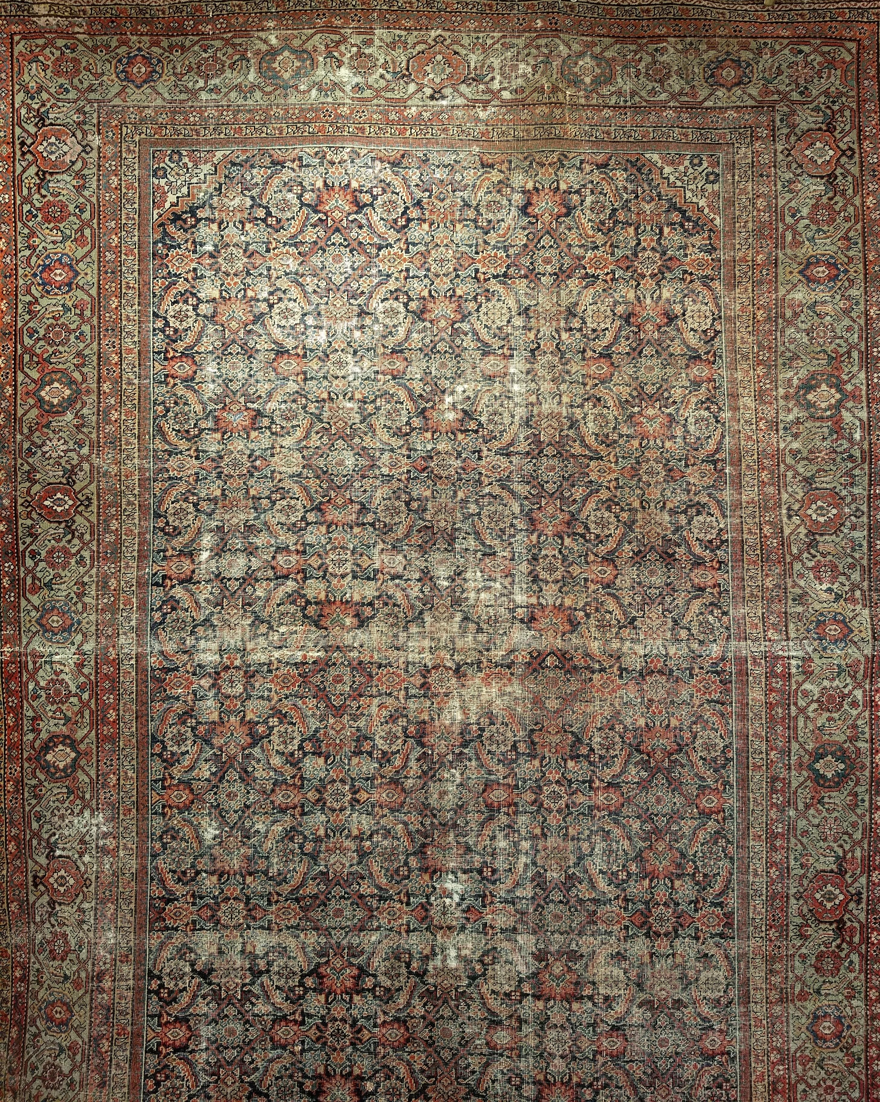19th century Persian Farahan in an all-over Herati pattern in a room or a gallery/library size.  This extremely finely hand woven Farahan rug from Western Persia has a “Herati” all-over pattern set in a navy blue color field with designs in brick