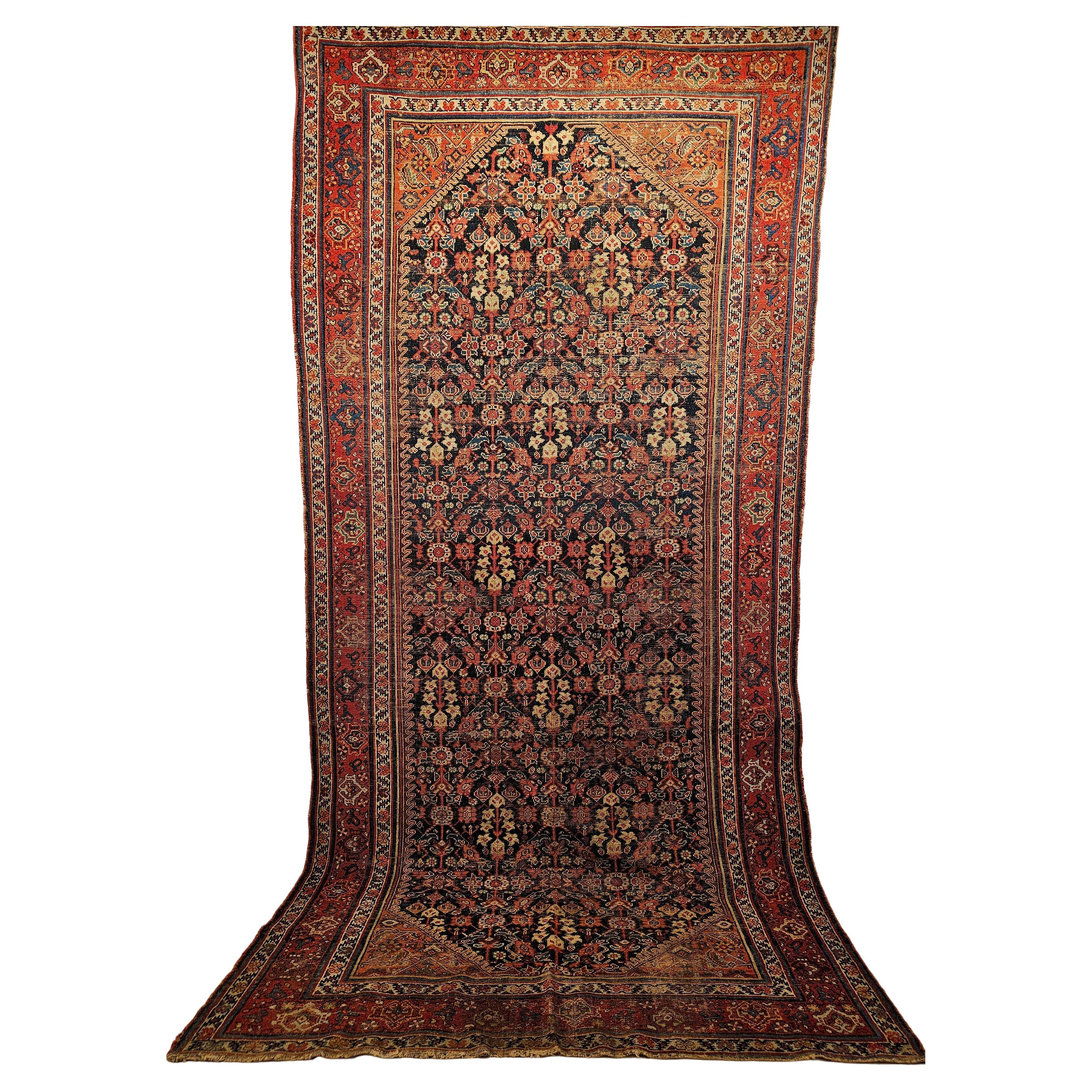A beautiful Persian Malayer gallery or library rug from the 4th quarter of the 1800s in an all-over design with an abrash navy blue field color.  The rug has a wonderfully large format geometric pattern on an abrash navy blue color background.  The