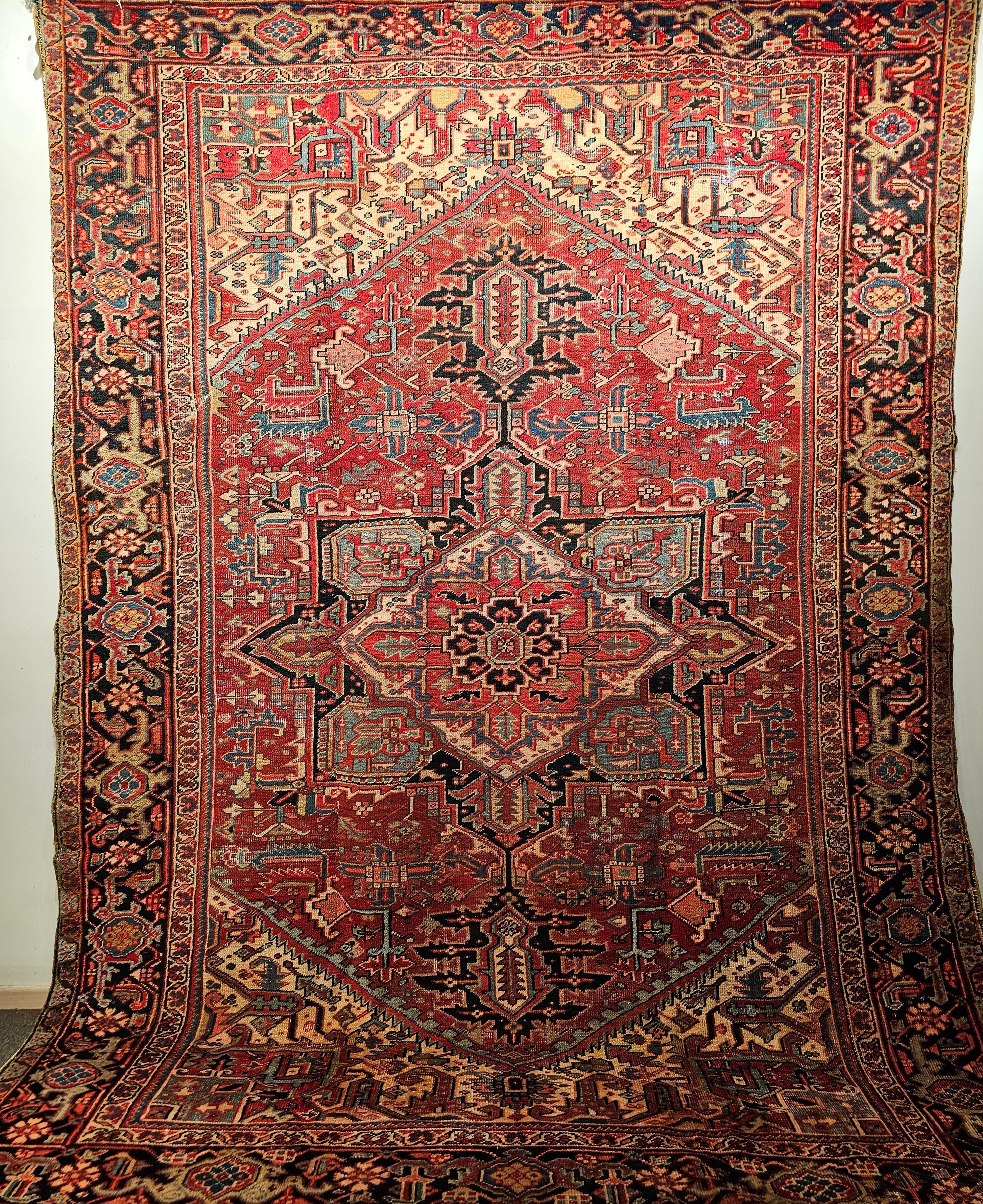 This Heriz rug from the 4th quarter of the 19th century shows the workmanship of the Azerbaijan village weavers of Northwest Persia. The Heriz has an open field design with the light yellow color in the spandrels and in the corners the brilliant