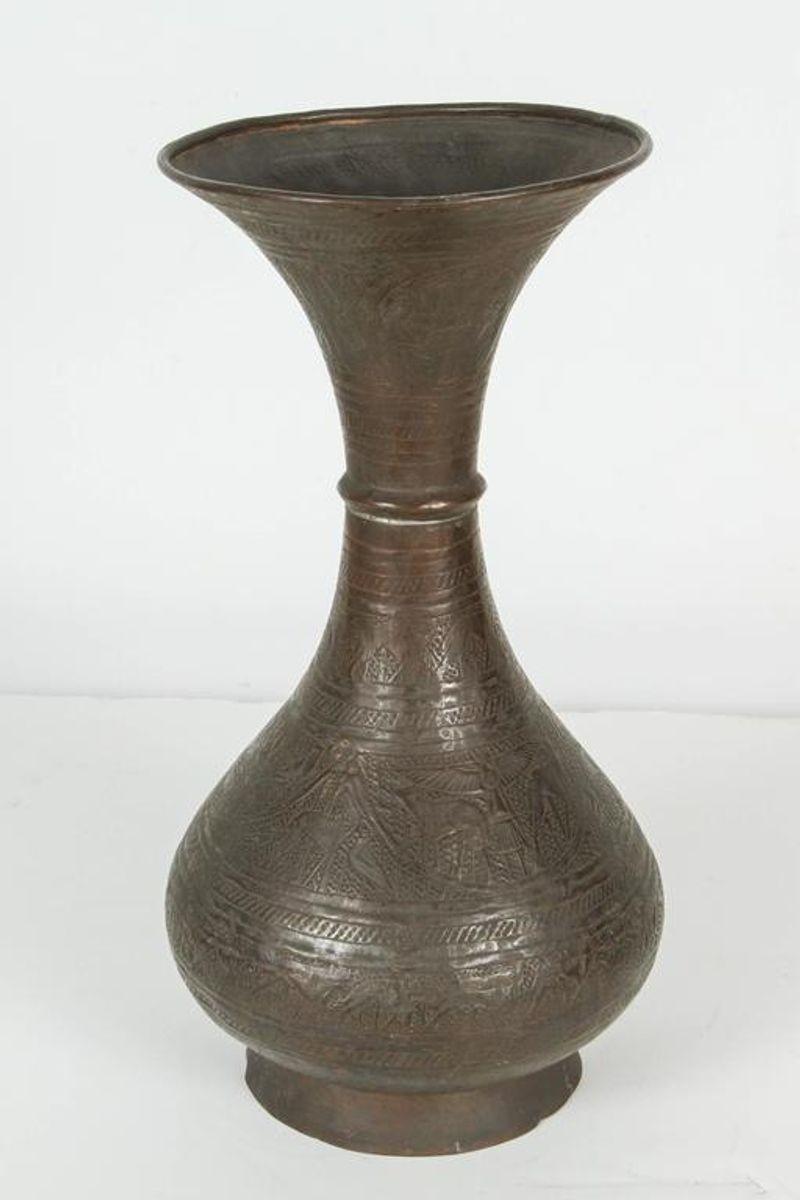 19th Century bronze color Persian Islamic vase with flared lip.
Brass patinated Islamic vase with flared lip, probably dating to the early 19th century.
Hand-chased and embossed brass with very dark bronze patina.
Decorated with very fine designs