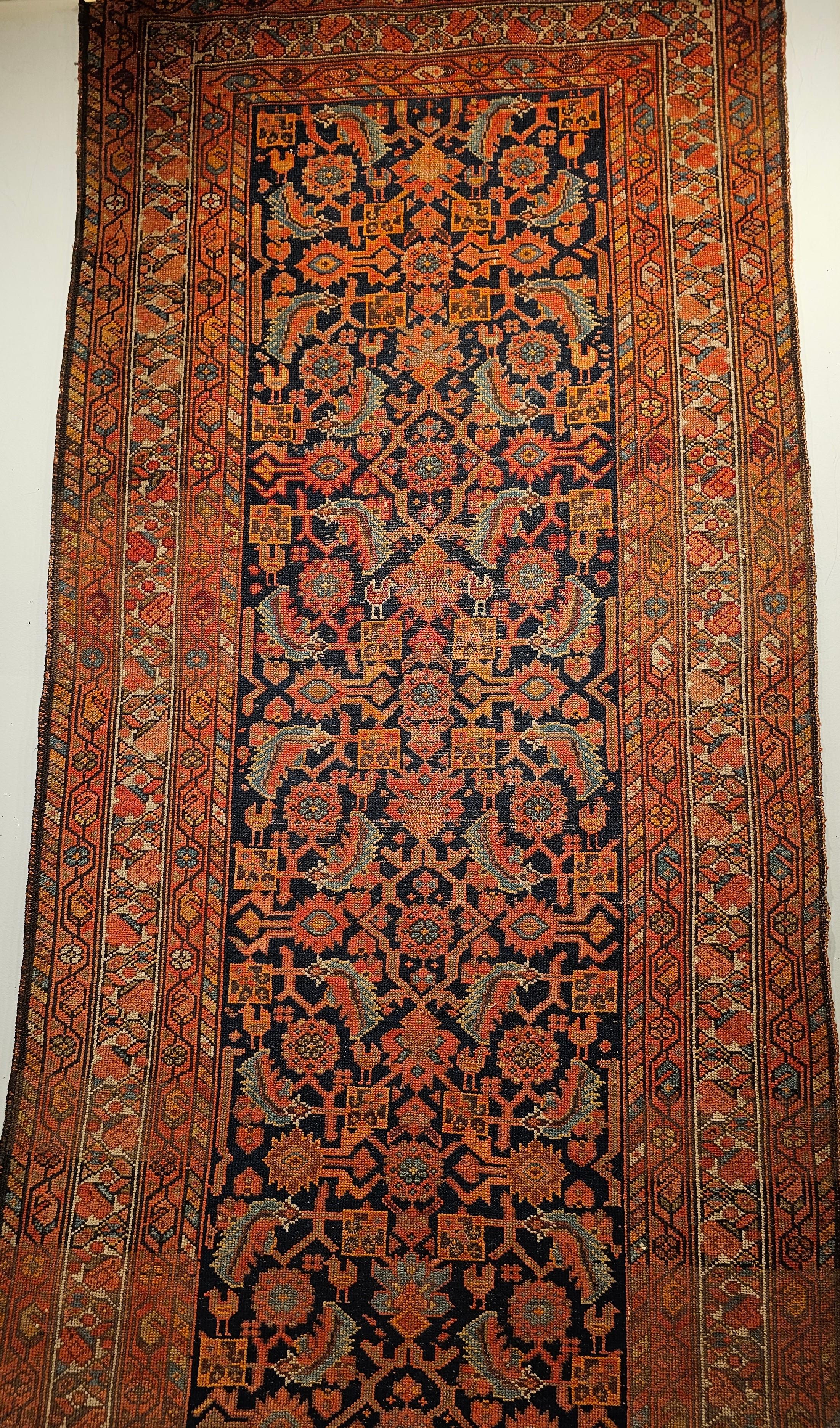 A stunning 19th century Persian Malayer long runner featuring an allover Herati pattern, handwoven in the late 1800s in the northwestern region of Persia. Set against a rich navy blue field, this village-woven rug showcases a harmonious palette of