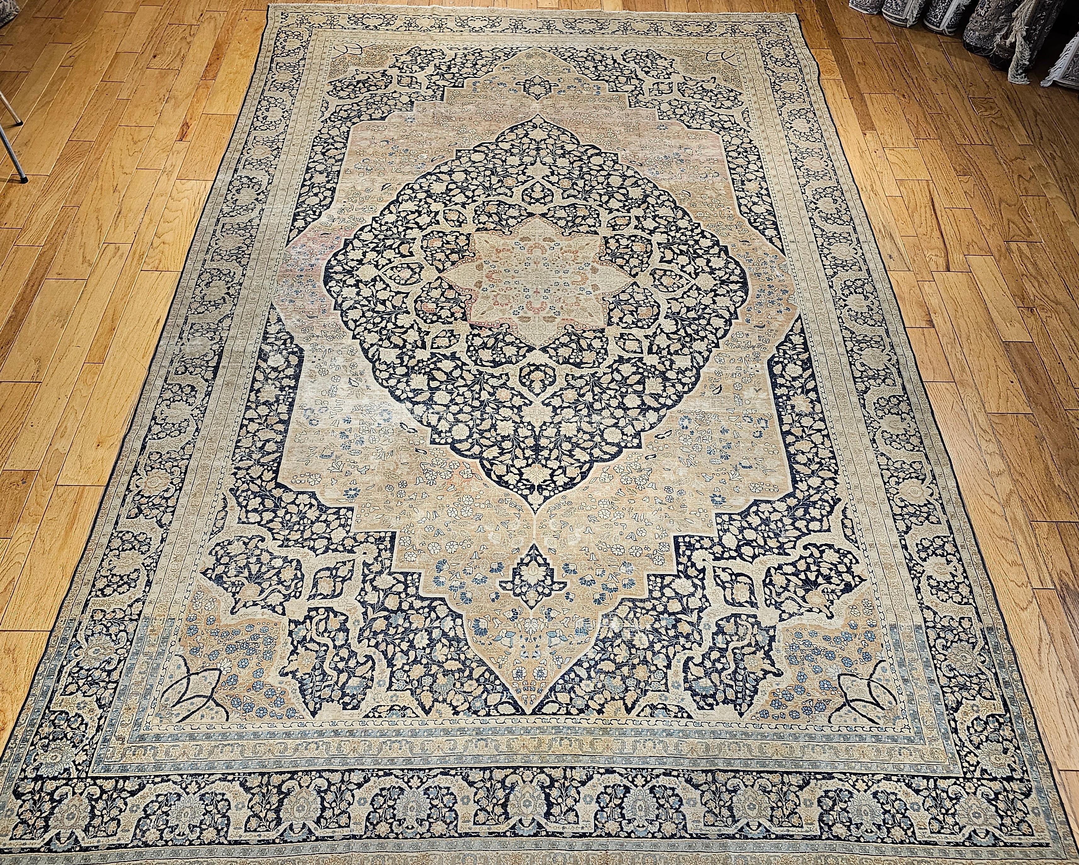 A beautiful Persian Tabriz from the workshop of world renowned master weaver Haji Jalili. Truly a masterpiece of Persian 19th-century weaving. A large central medallion integrates design in cream color set in an indigo ground, sand, baby blue, pale