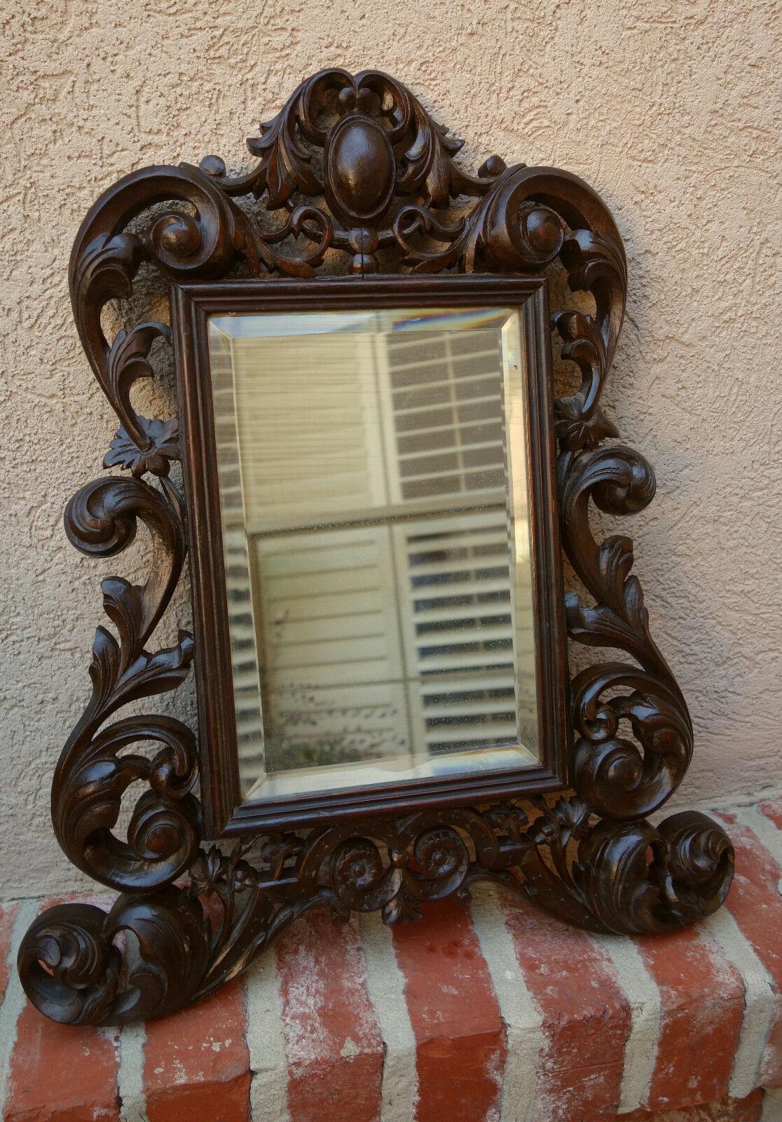 ~ Direct from France
~ Another fabulous antique French beveled wall mirror!
~ Very unique style, an unusually shaped design that just “speaks French”!
~ Lavish open carved scroll designs with large oval medallion crown
~ Rich dark finish and lovely