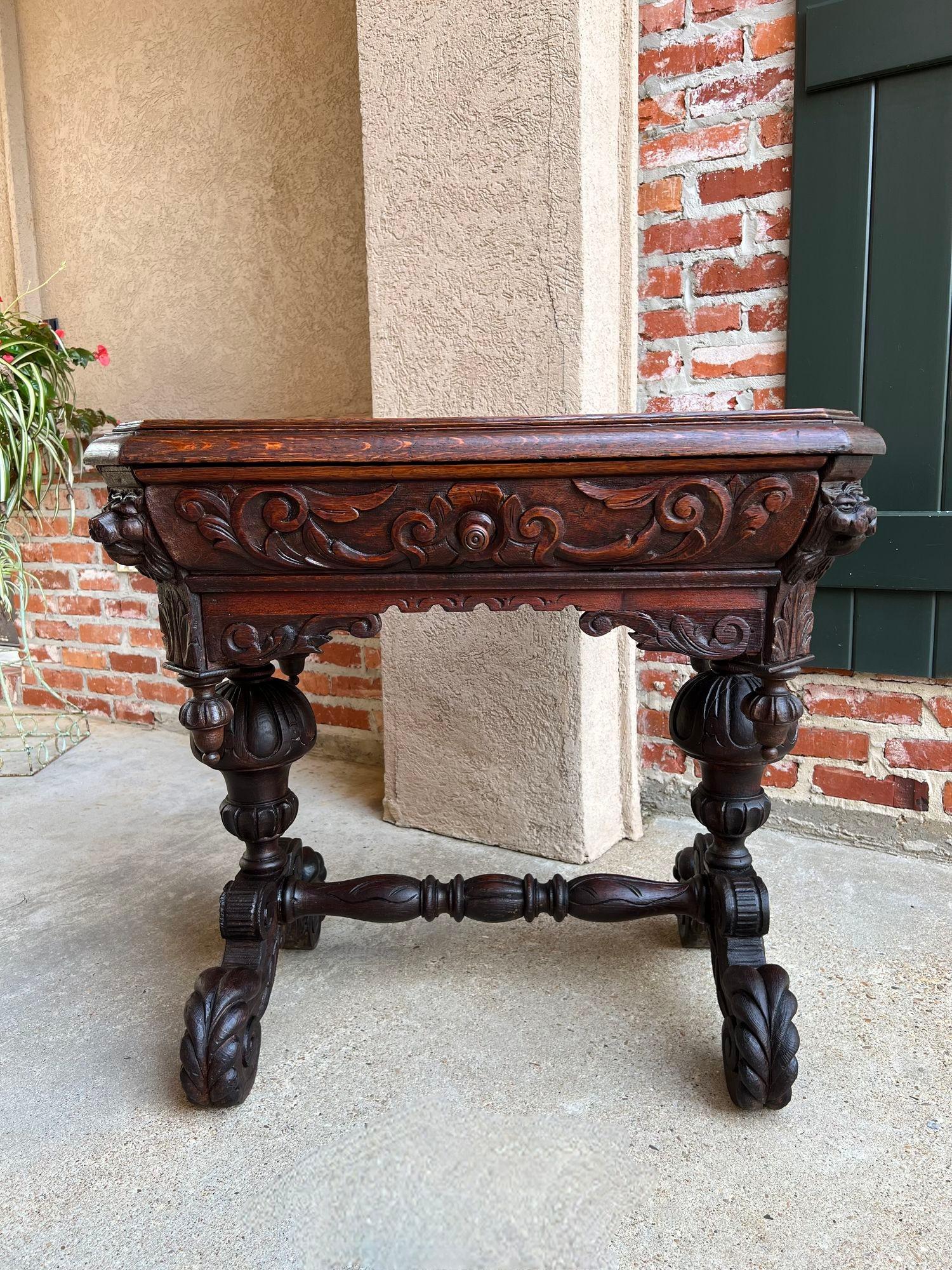 19th century Petite English sofa table library desk renaissance carved oak gothic.
 
Direct from London, England, a very petite and highly carved antique English sofa table or writing desk.
 Incredible detailed carving and captivating features that