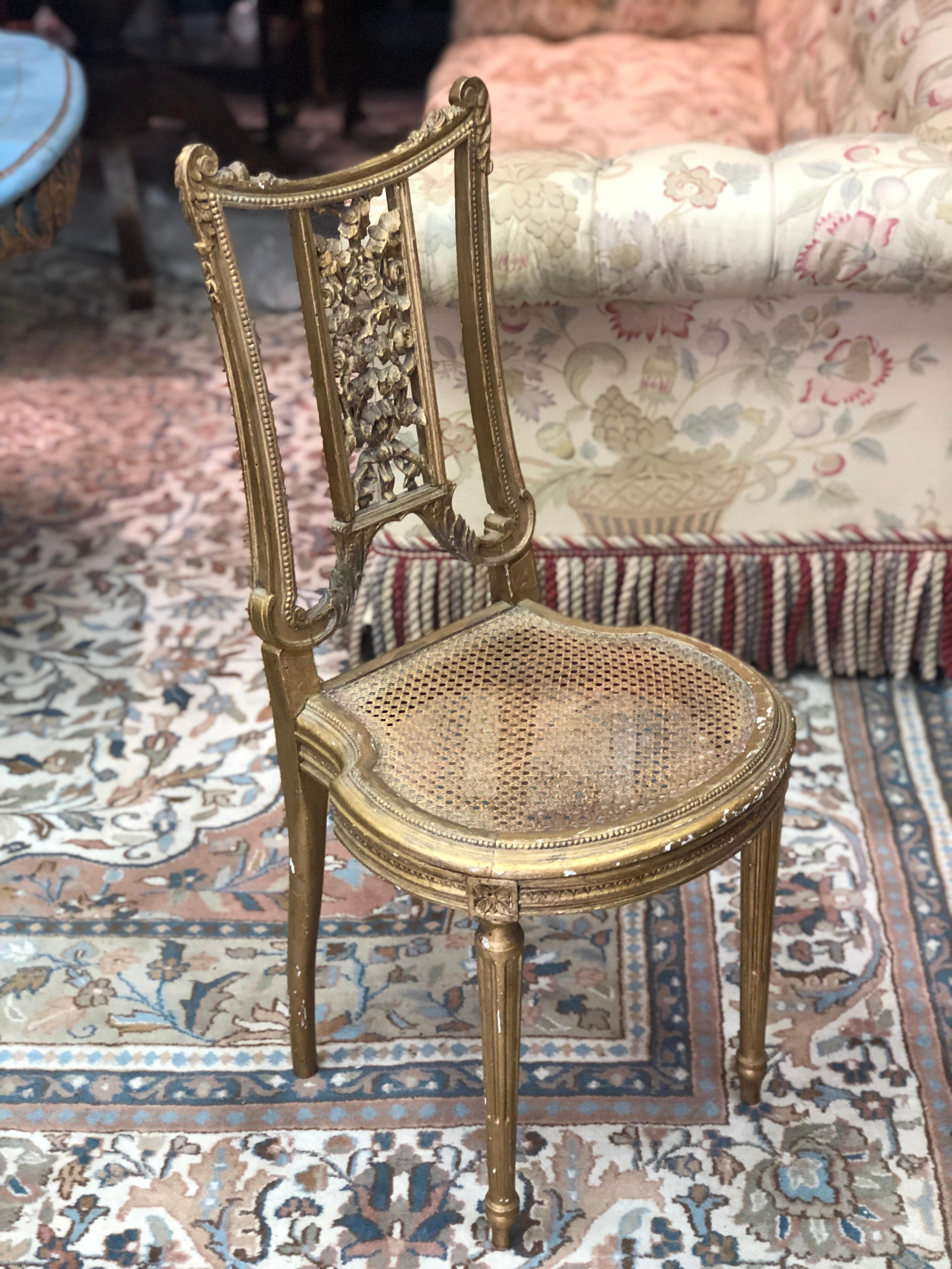 Petite French ballroom side chair, in Louis XVI style having a giltwood frame with carved roses at the back and the seat is caned.
France, circa 1870.
 