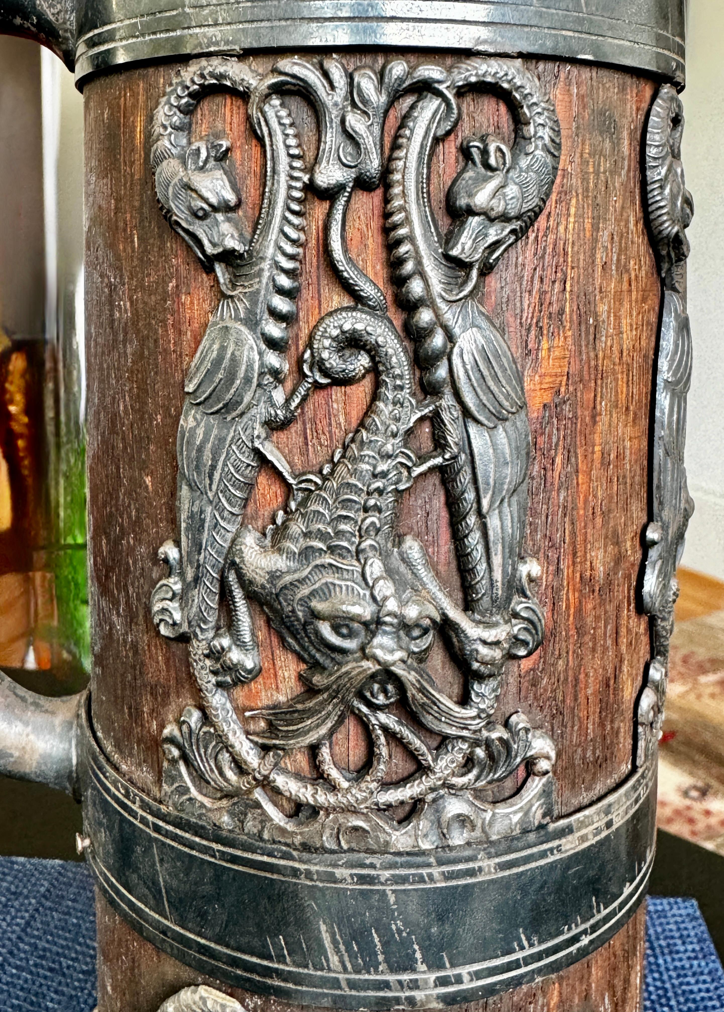 19th Century Pewter and Wood Kronheim Oldenbusch Stein

Decorated with fantasy dragon and walrus with tails of seals

11.5
