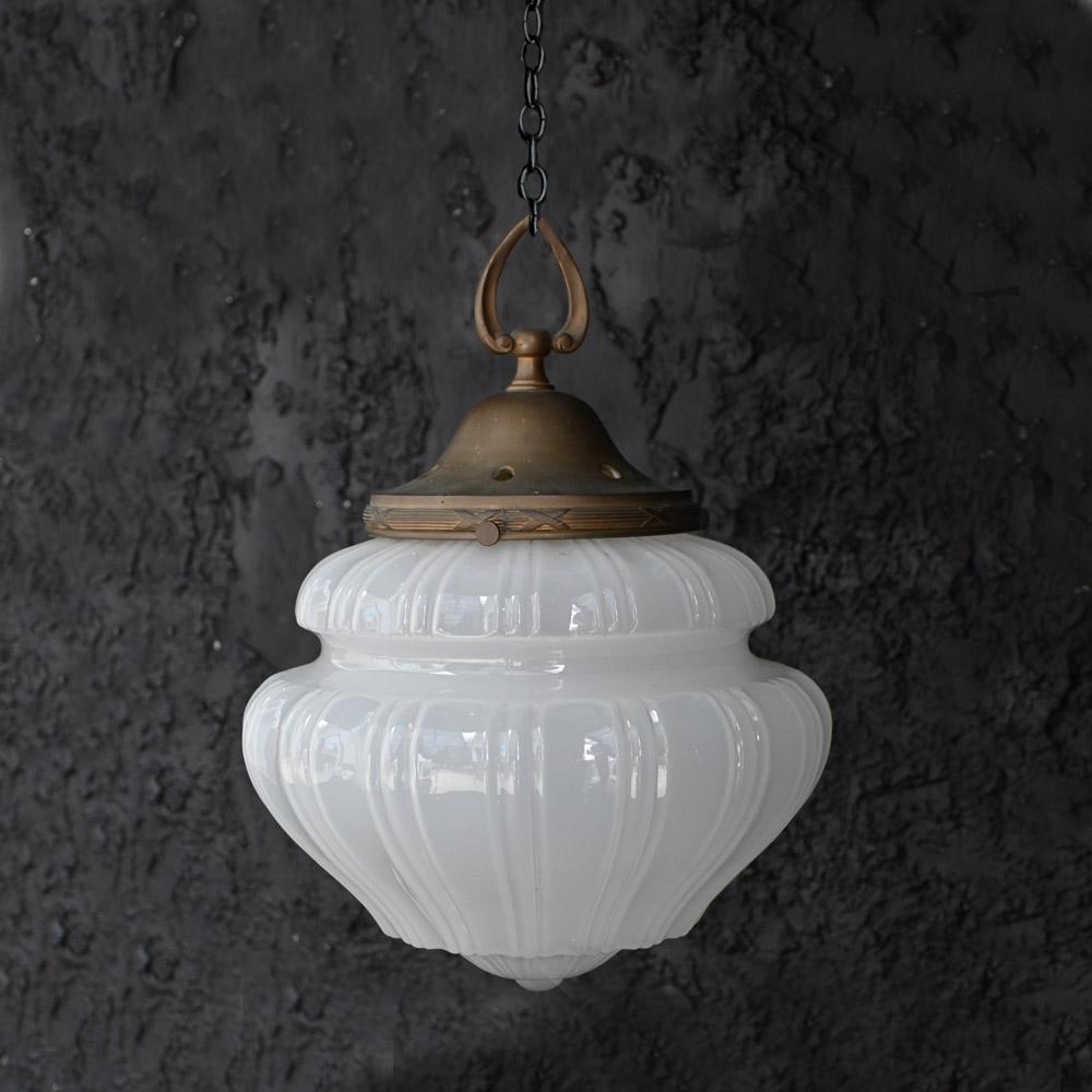 19th century pharmacy moonstone glass pendant light
A mid-19th century English fluted opaque moonstone glass shade. Supported by its original brass gallery with a wonderful untouched patina. The moonstone shade boasts a robust natural yet delicate
