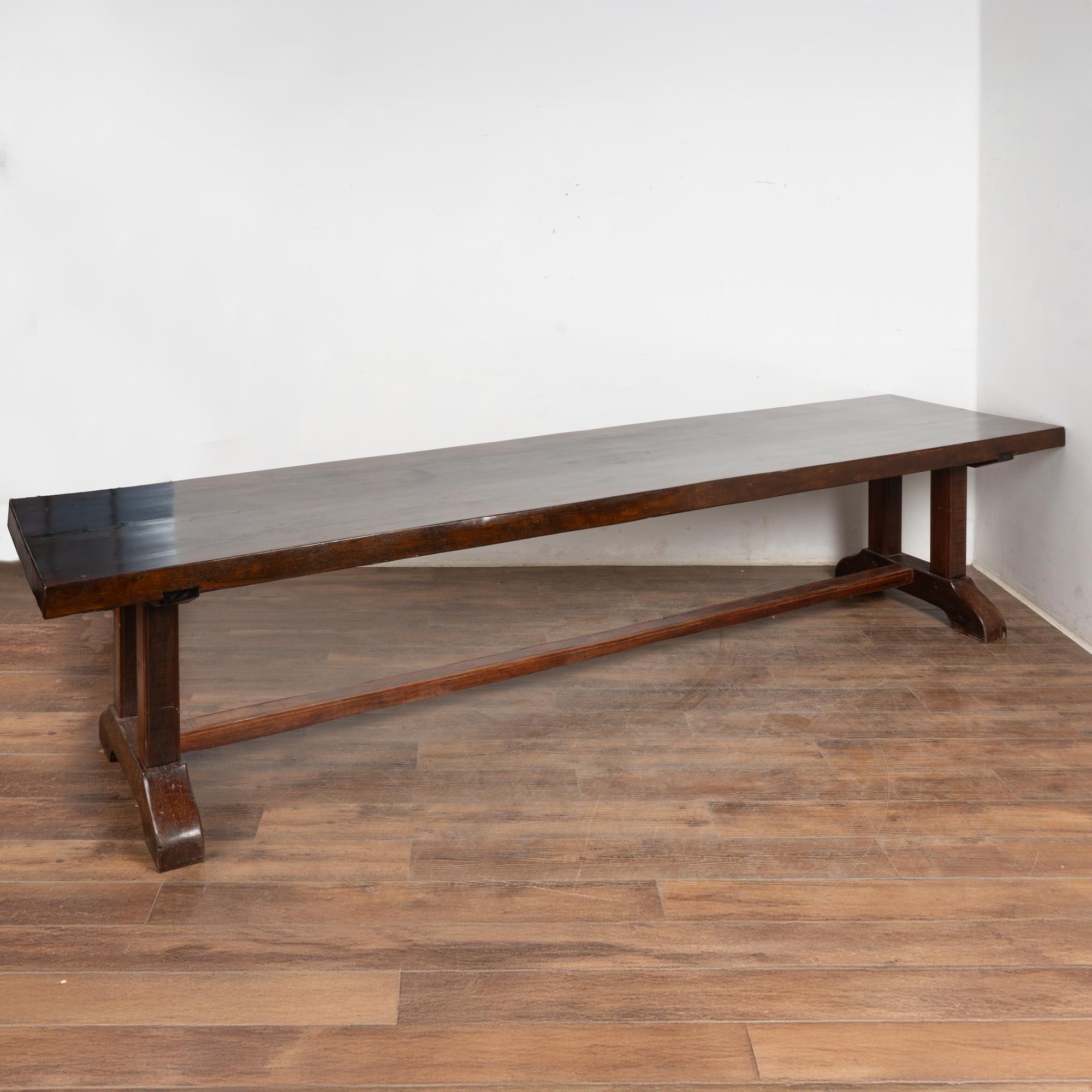 At just over 12' long, this dramatic dining table will make a great gathering place in today's modern home.
The clean lines and long top are impressive; rich character is revealed in the scratches, distress, abrasions and large butterfly repairs