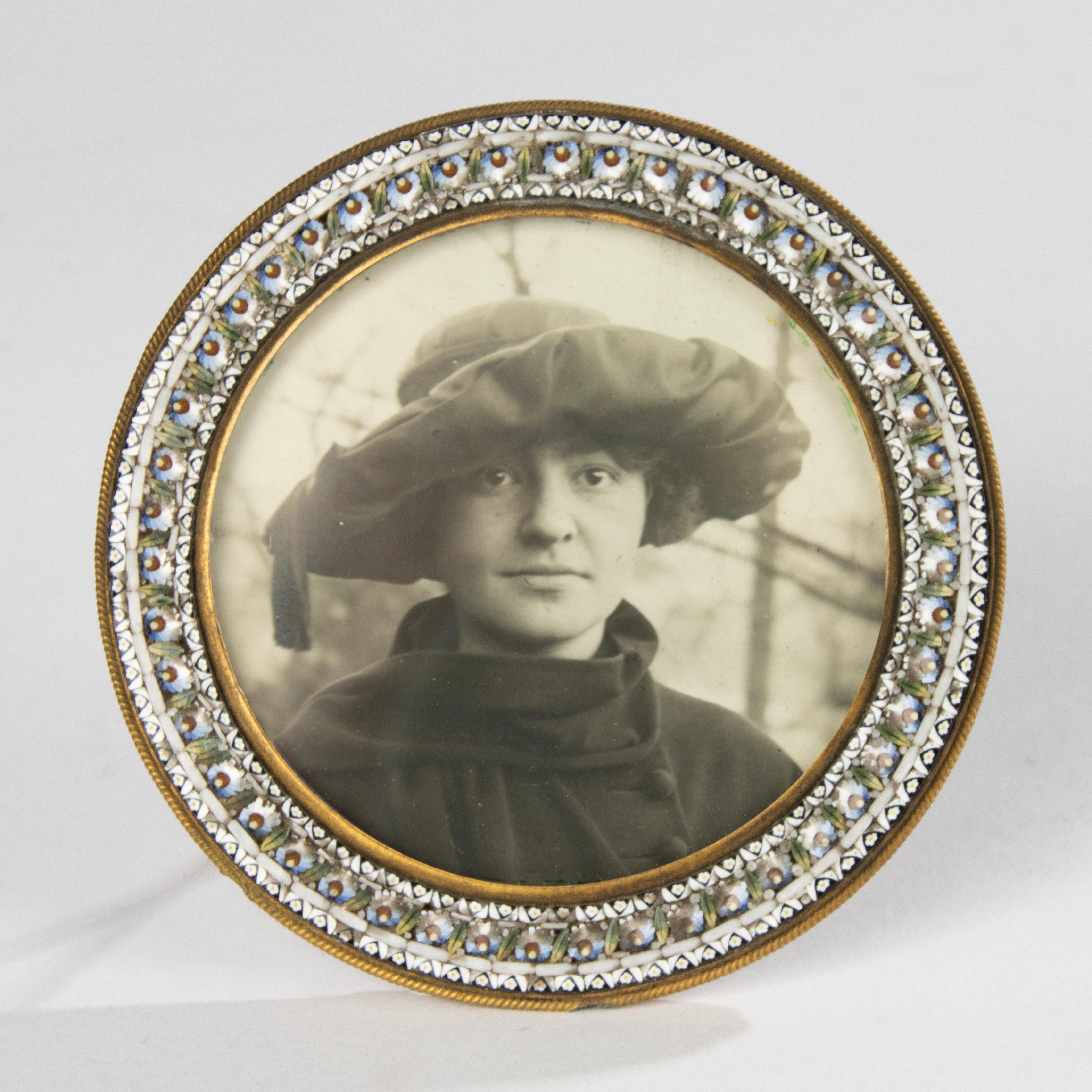 A beautiful antique photo frame, dating from the end of the nineteenth century, beautifully decorated with micro mosaic.
They are very small stones of colored glass, a typical technique from Venice.

Dimensions: the frame is 8 x 8 x 7 cm. The