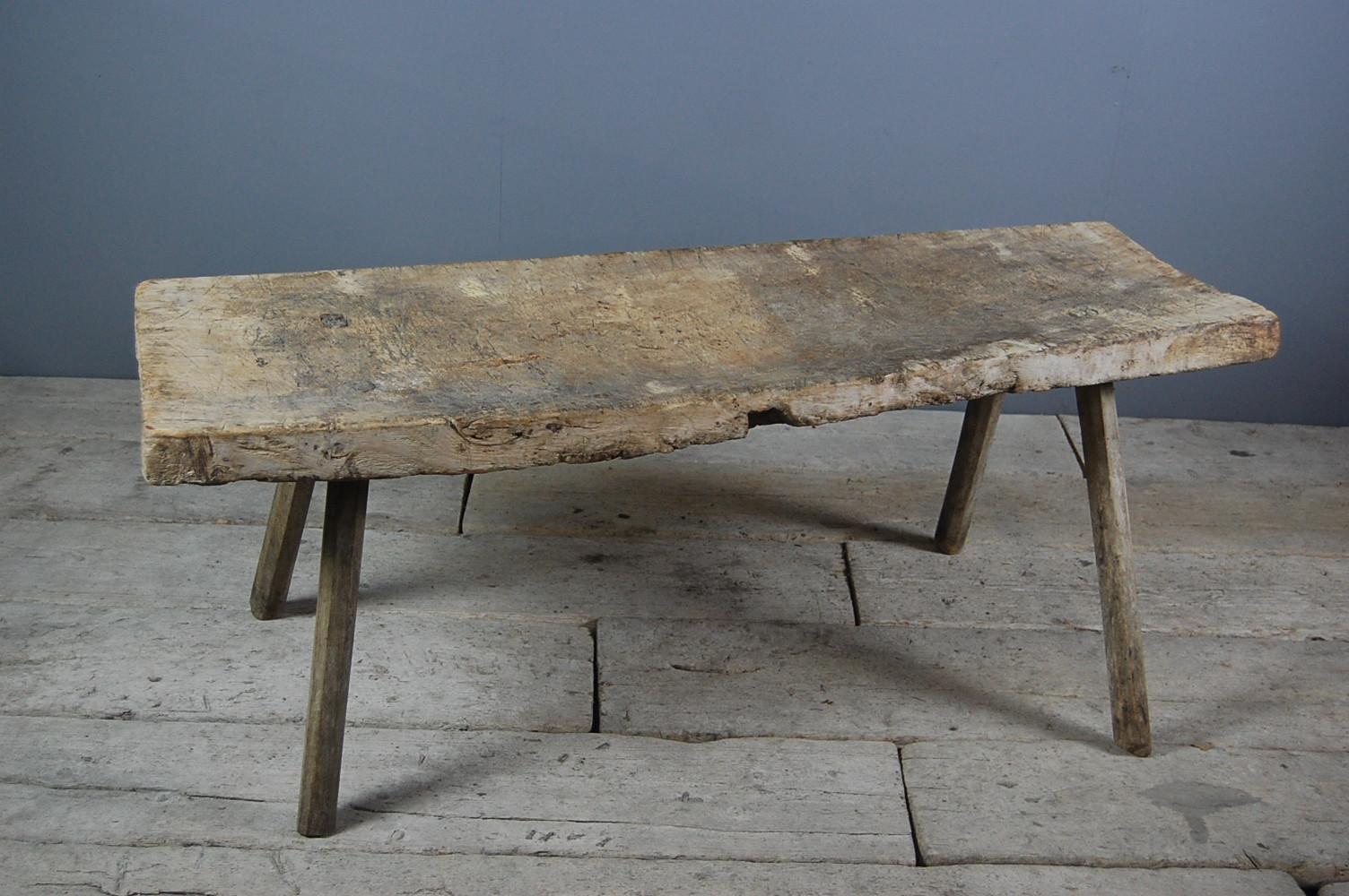 Untouched Primitive country pig bench, slightly warped from use, single slab aged dry surface. Stands well, France, circa 1850.