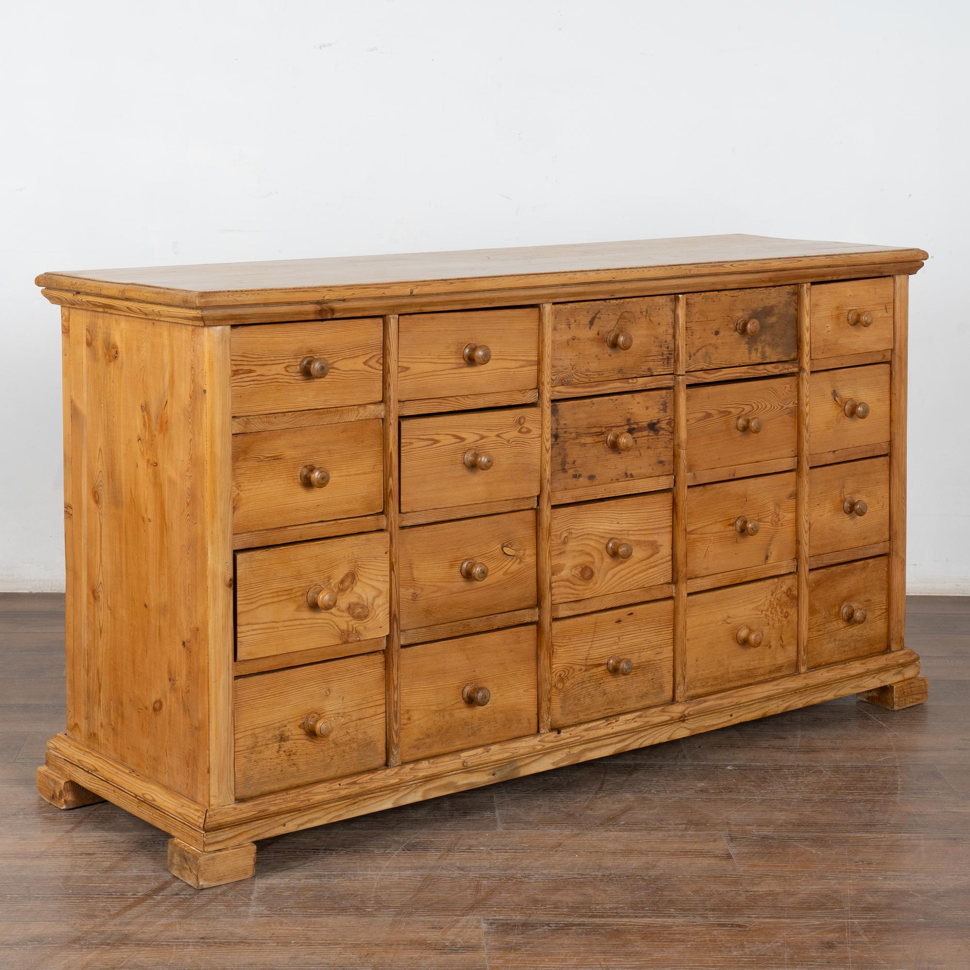 Fun and function combine in this pine chest of 19 drawers. This delightful pine apothecary originally served as a shop counter or storage cabinet.
Counters similar to this were used throughout shops in European and are a great way to incorporate old