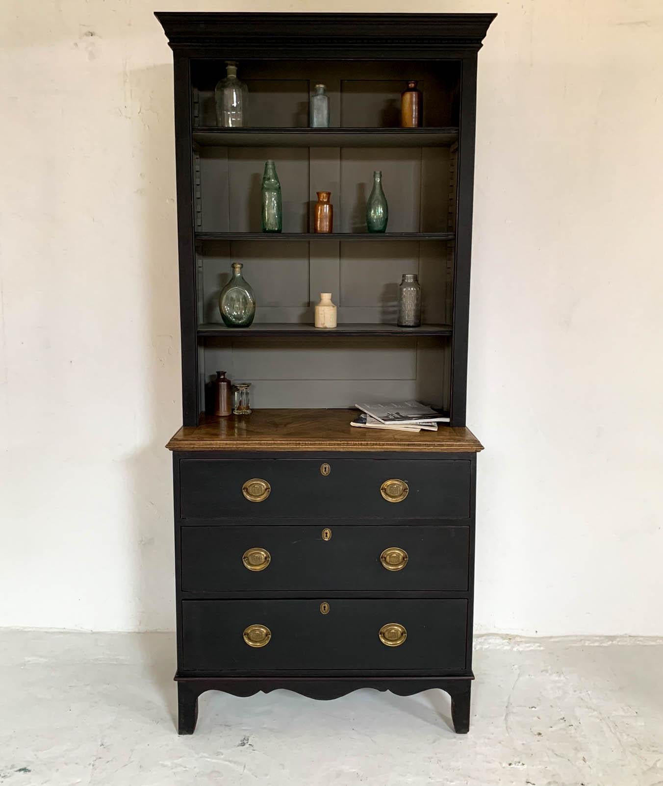 Pine bookcase featuring three drawers with original brass handles, parquet oak top and later added top bookcase. Painted black and gently aged to reveal hints of red paint beneath and grey inside the bookcase. A really beautiful and practical piece