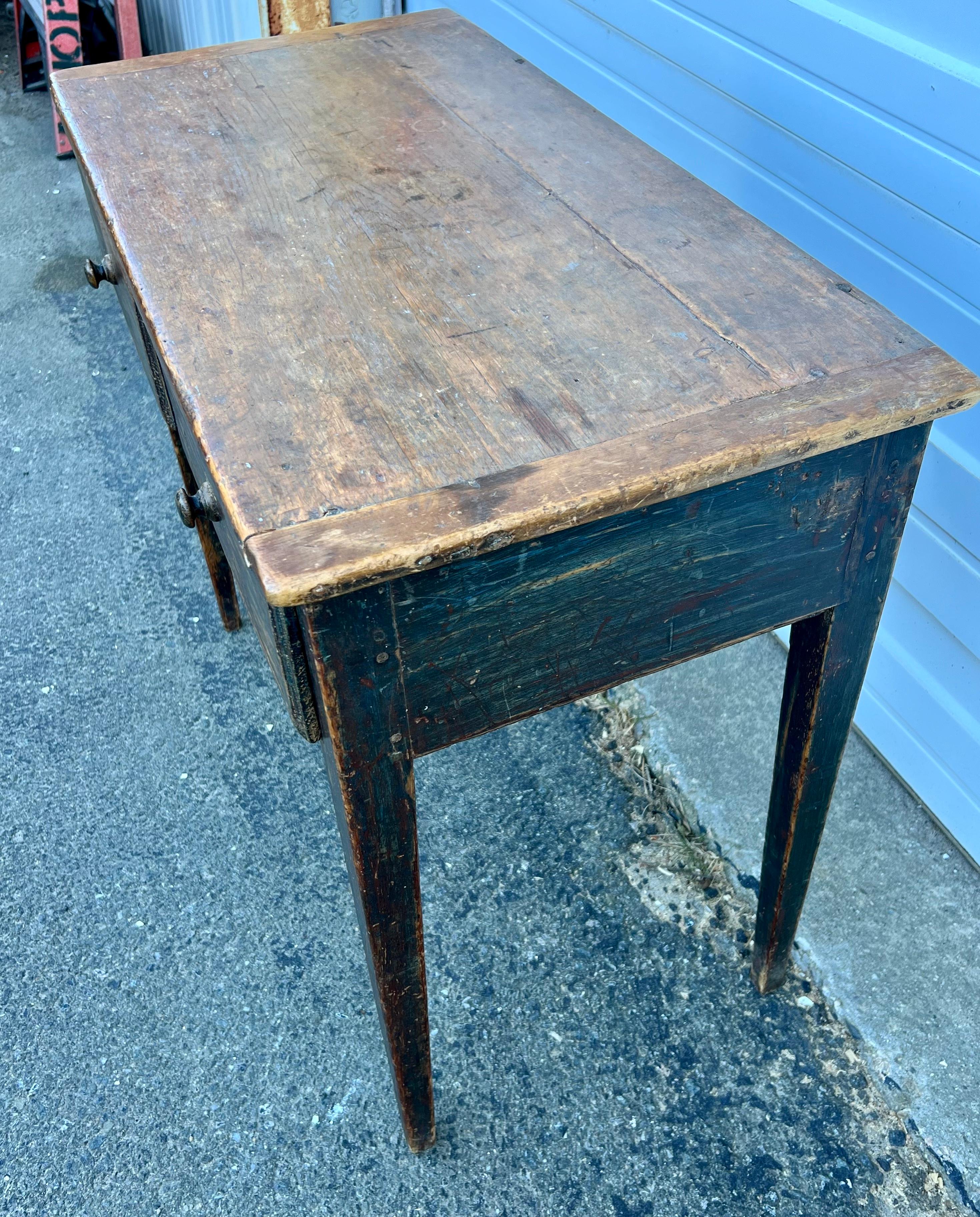 Pine Console table with traces of old green, red, and blue paints.  Top with breadboard ends above two side-by-side drawers, on tapered legs.  Circa 1840.