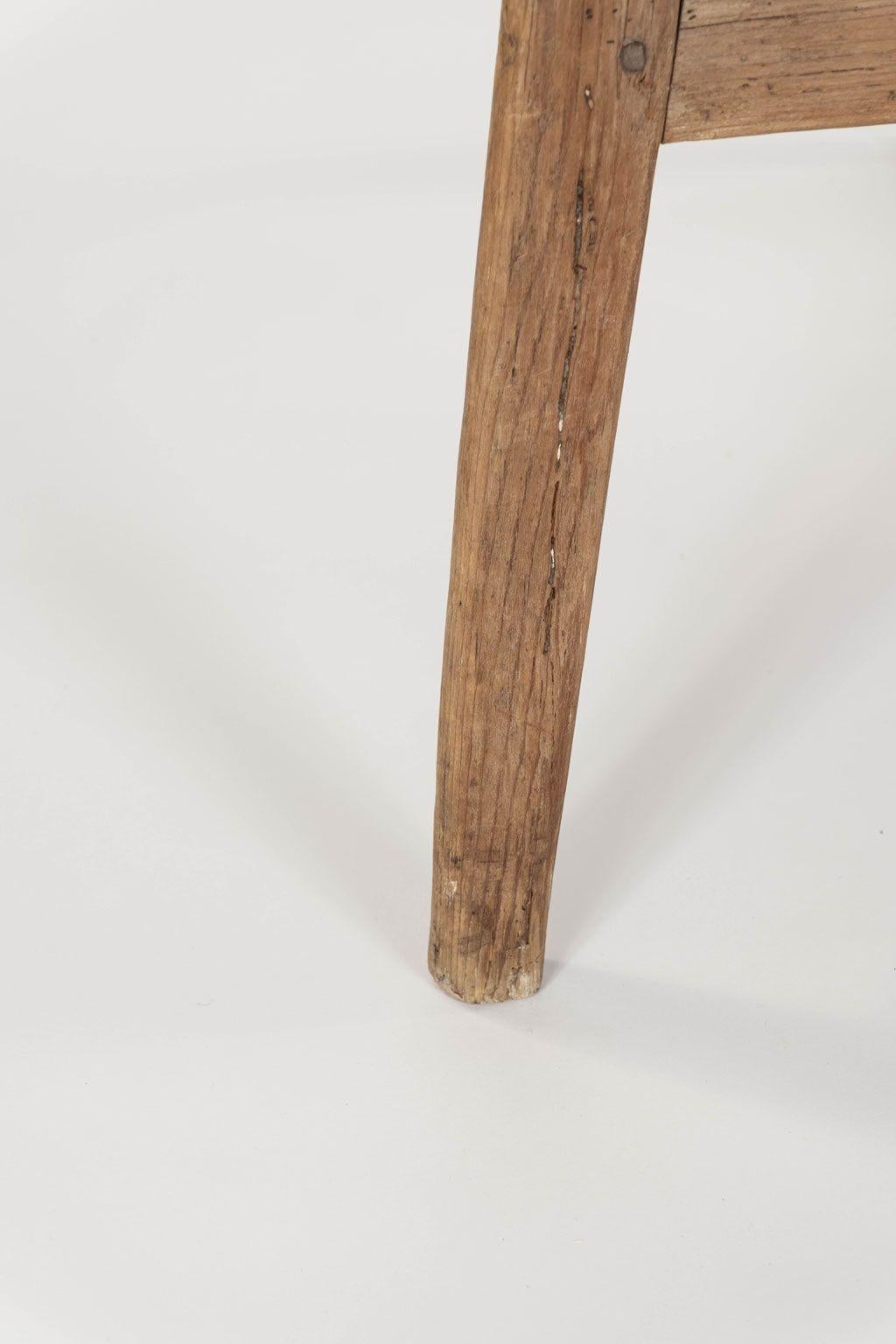 19th century pine cricket table: scrubbed circular top upon three chamfered legs with under-tier shelf.